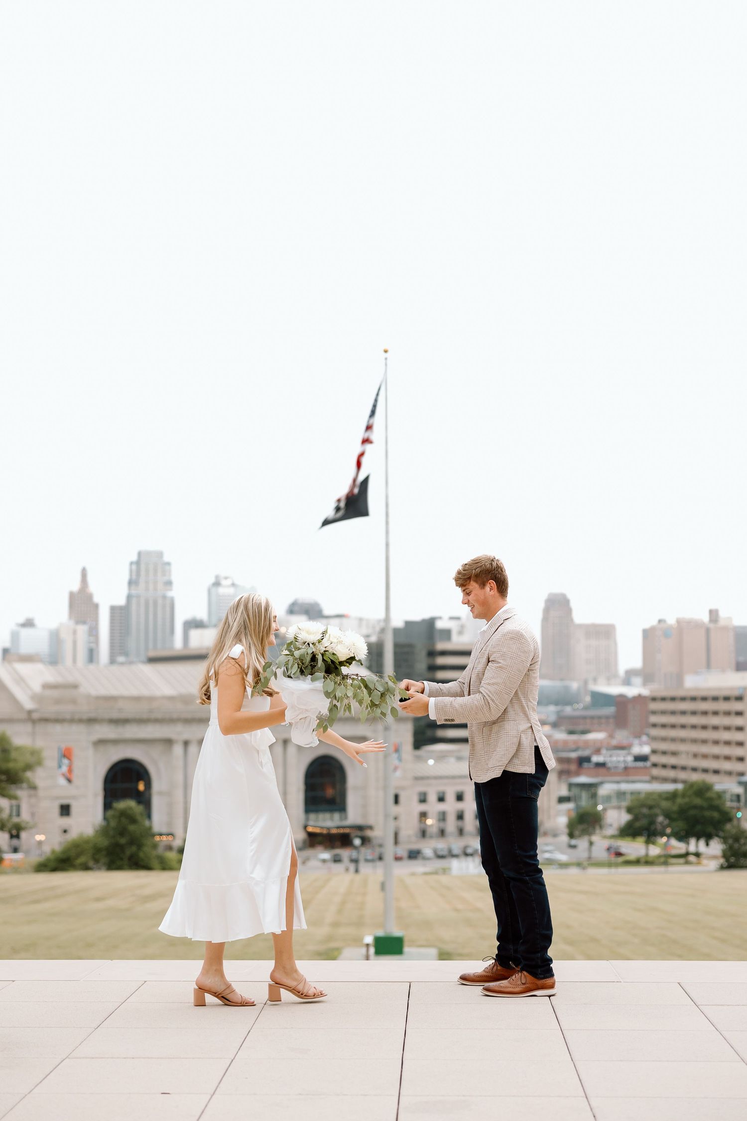 A series of progressive photos showing a sweet surprise proposal moment on a rooftop overlooking a city skyline.