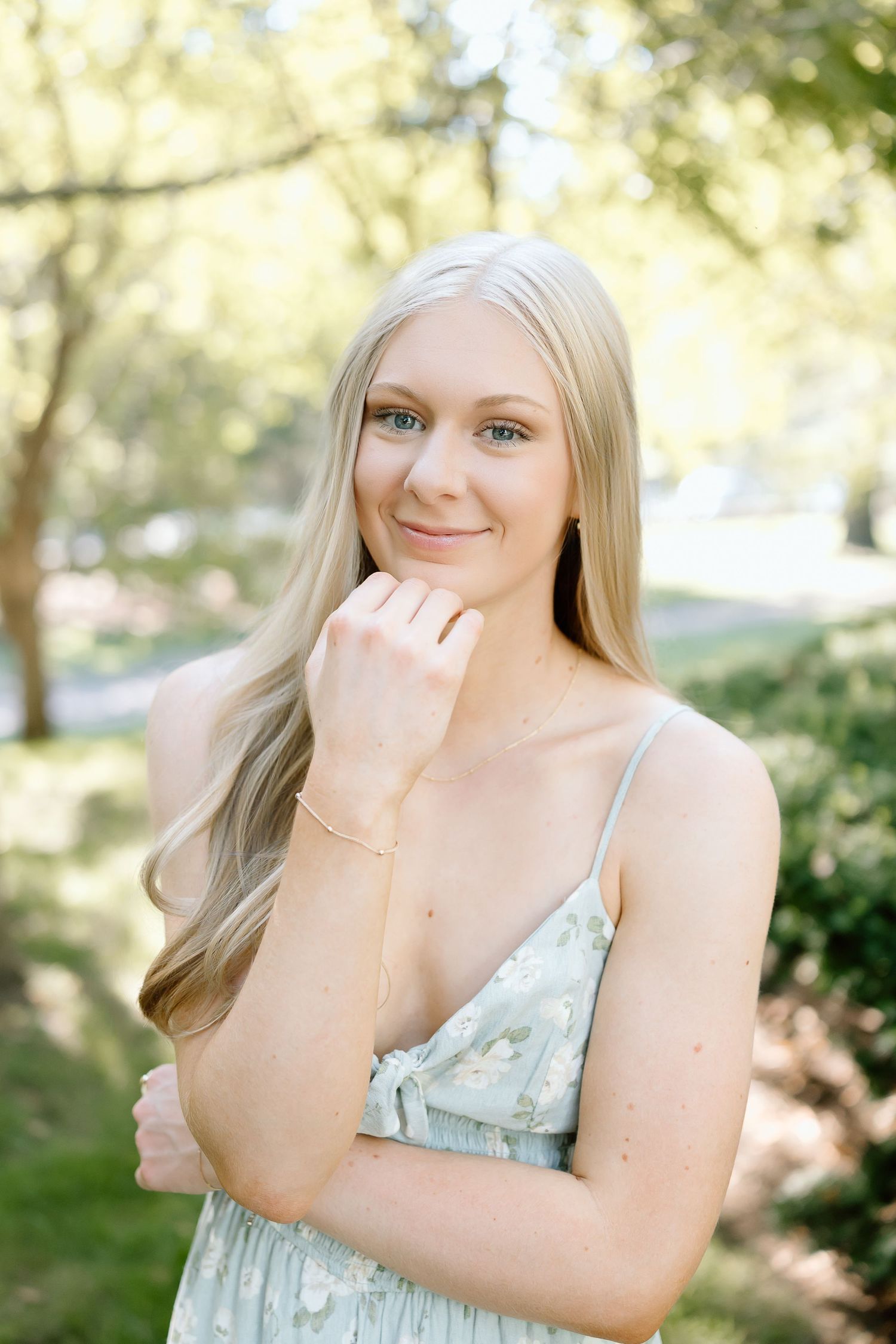 A series of outdoor portrait photographs in a natural setting with soft lighting and greenery in the background.