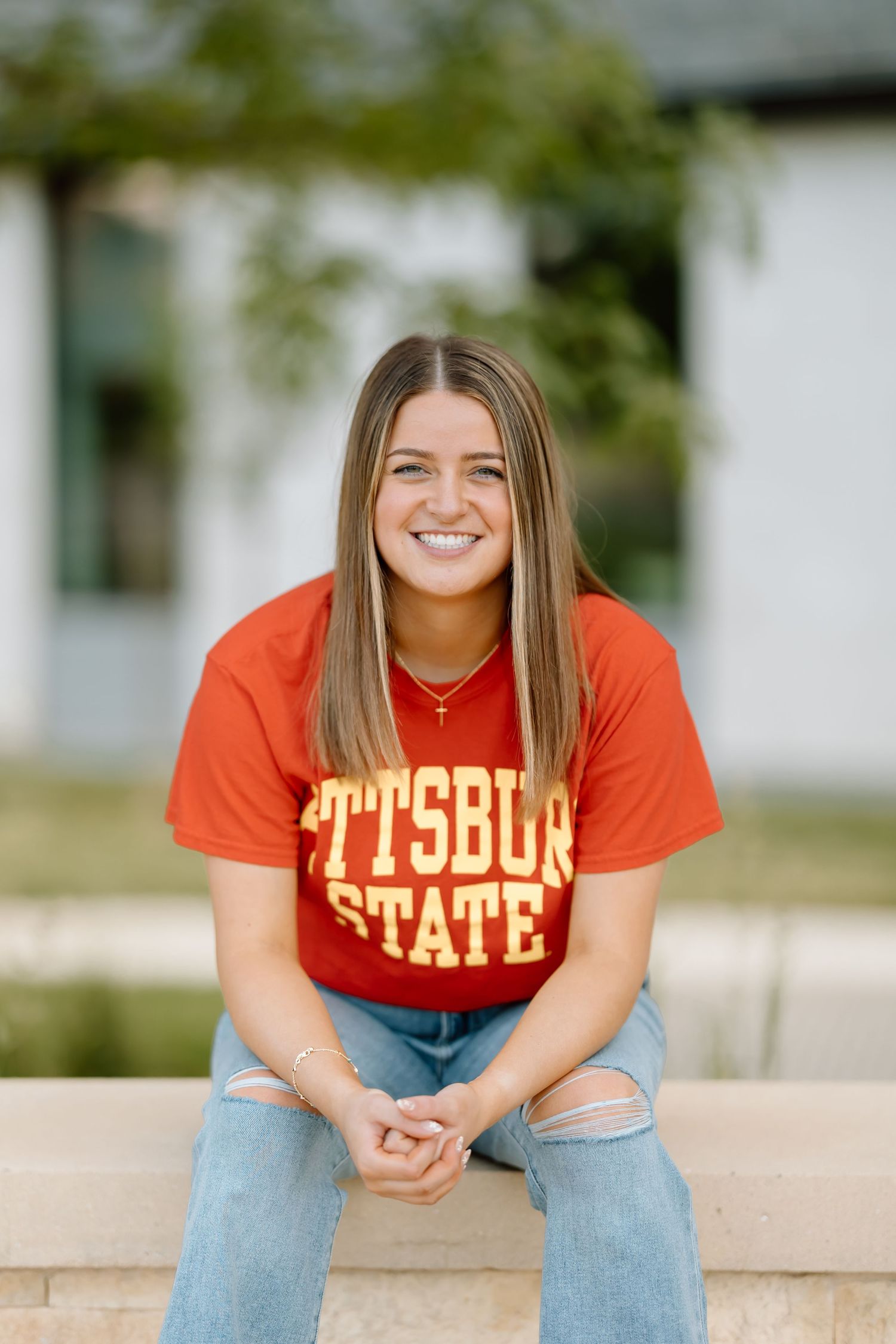 A series of casual portraits showing someone wearing an orange Pittsburg State sweatshirt and jeans while sitting outdoors.