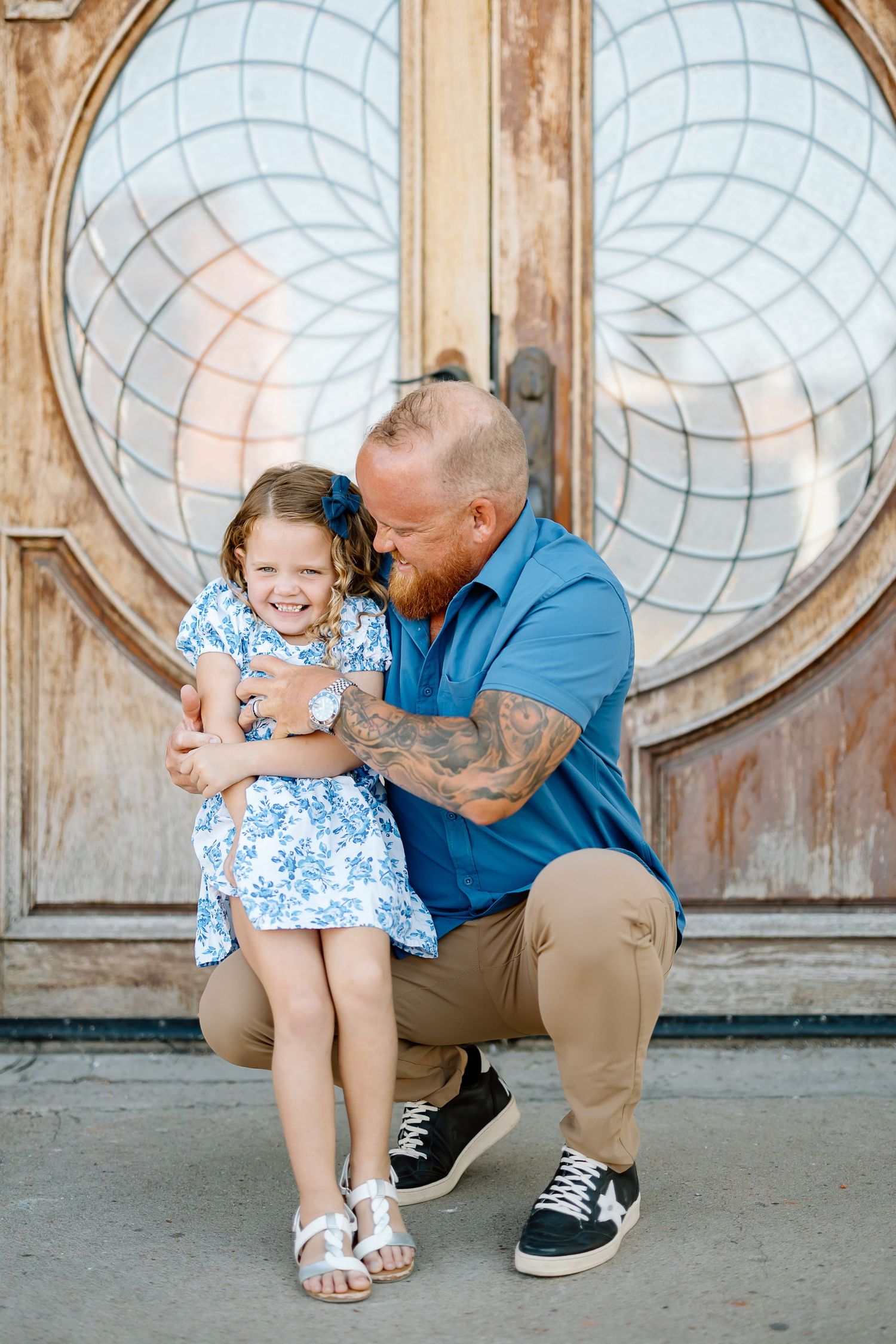 Heartwarming interaction photographed in sequence against vintage wooden door with round windows.