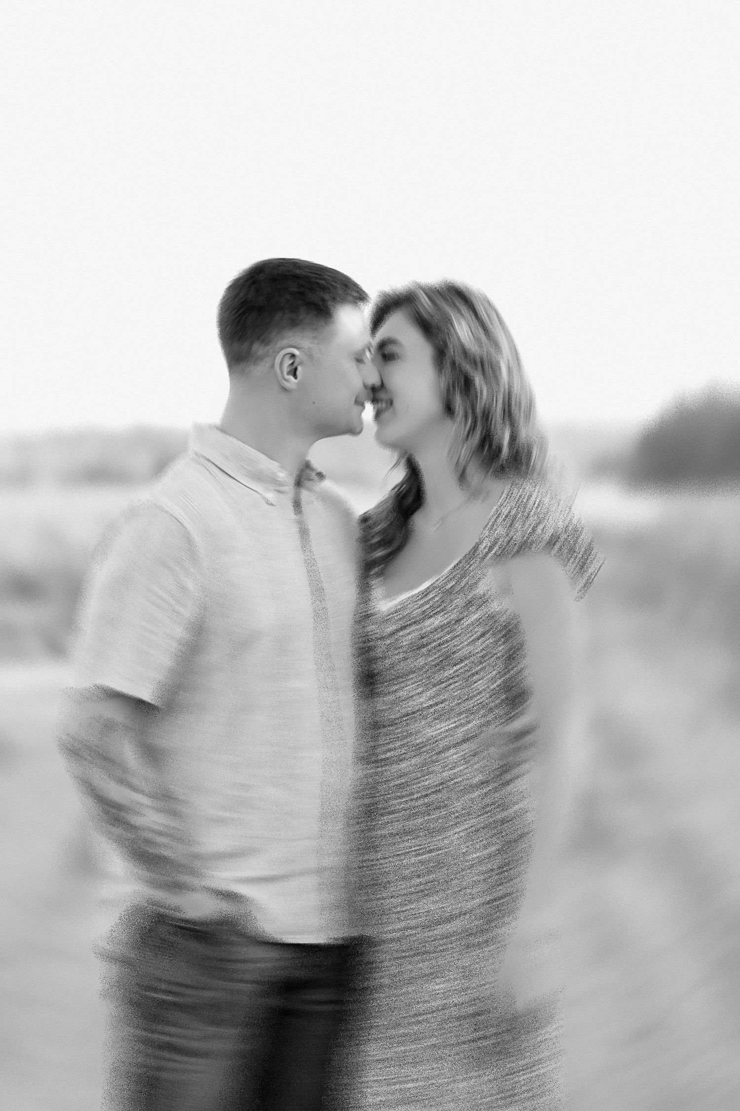 A series of romantic black and white photos showing a couple spinning and kissing in a dreamy motion blur effect.