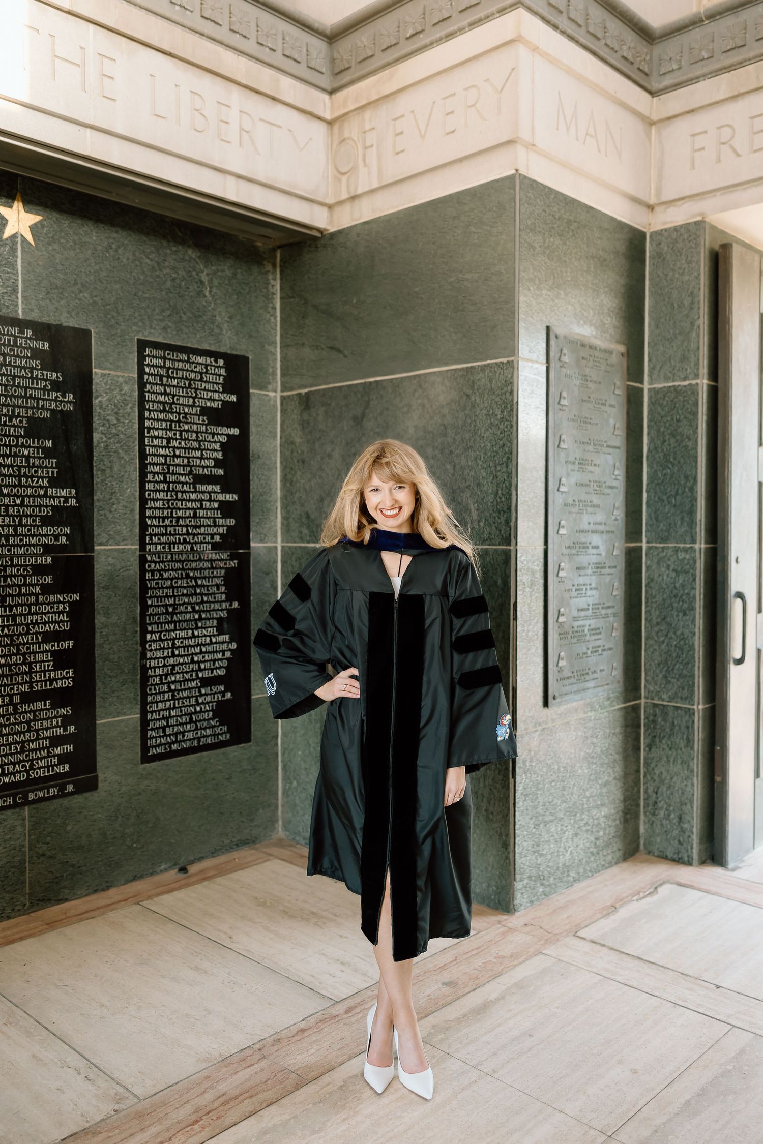 A series of graduation photos in front of a memorial wall with black plaques showing white text inscriptions.