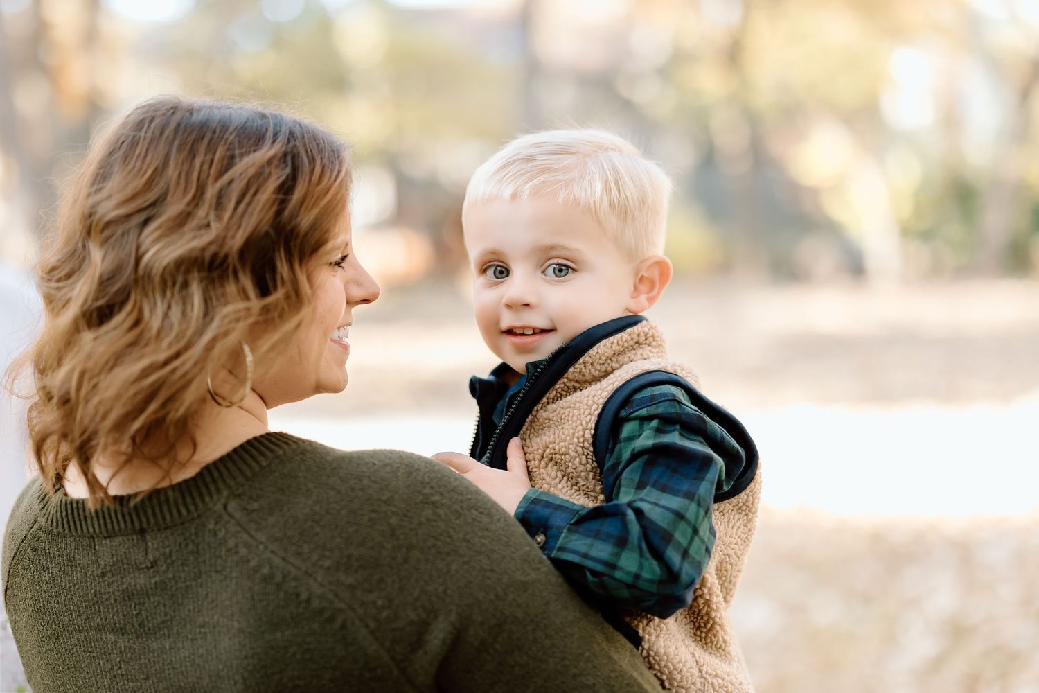 A heartwarming moment between parent and child captured in warm autumn light.