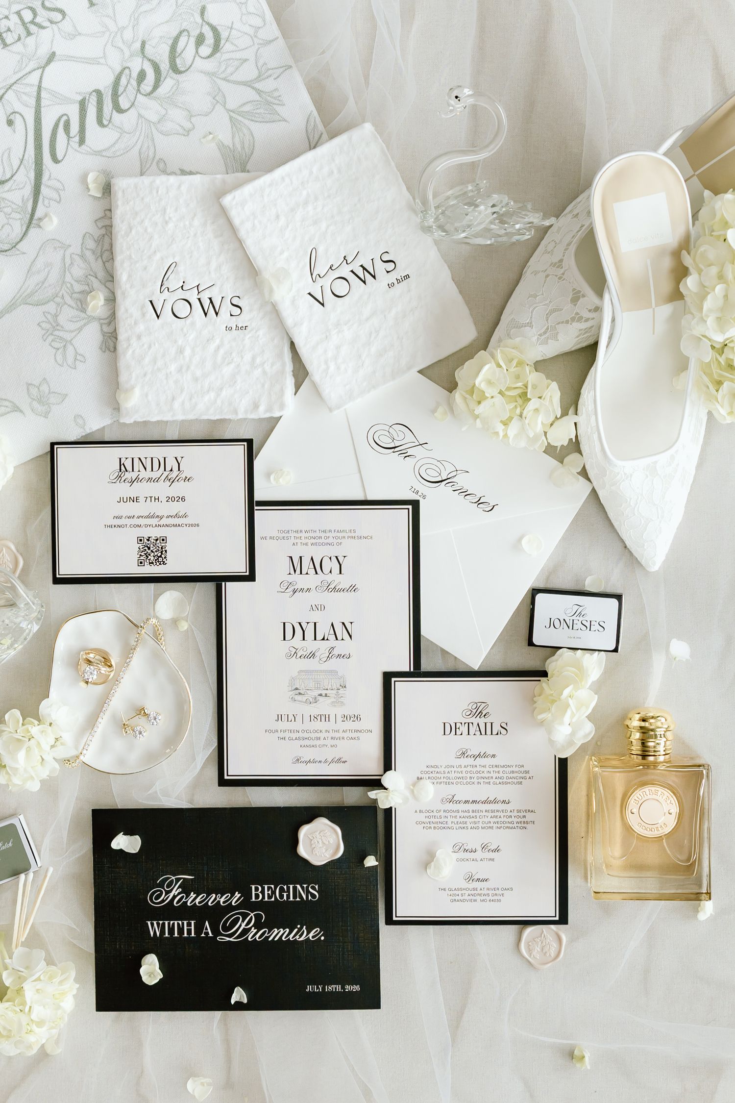Elegant black and white wedding stationery suite with vow books, invitation, details card, and white heels.
