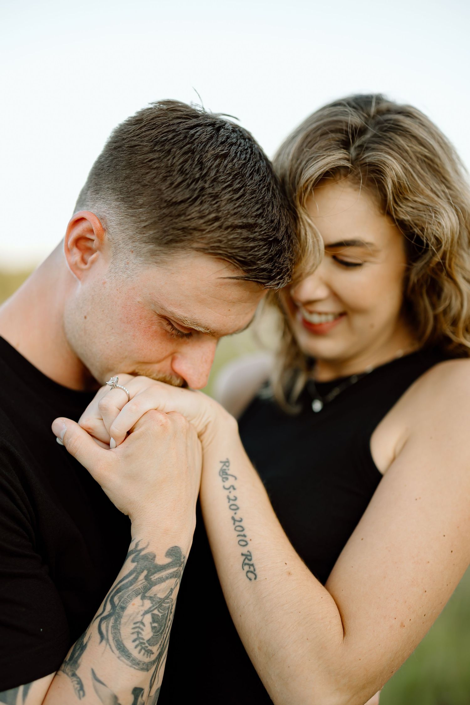 A series of intimate close-up shots showing a couple sharing tender kisses with visible tattoos on their arms.