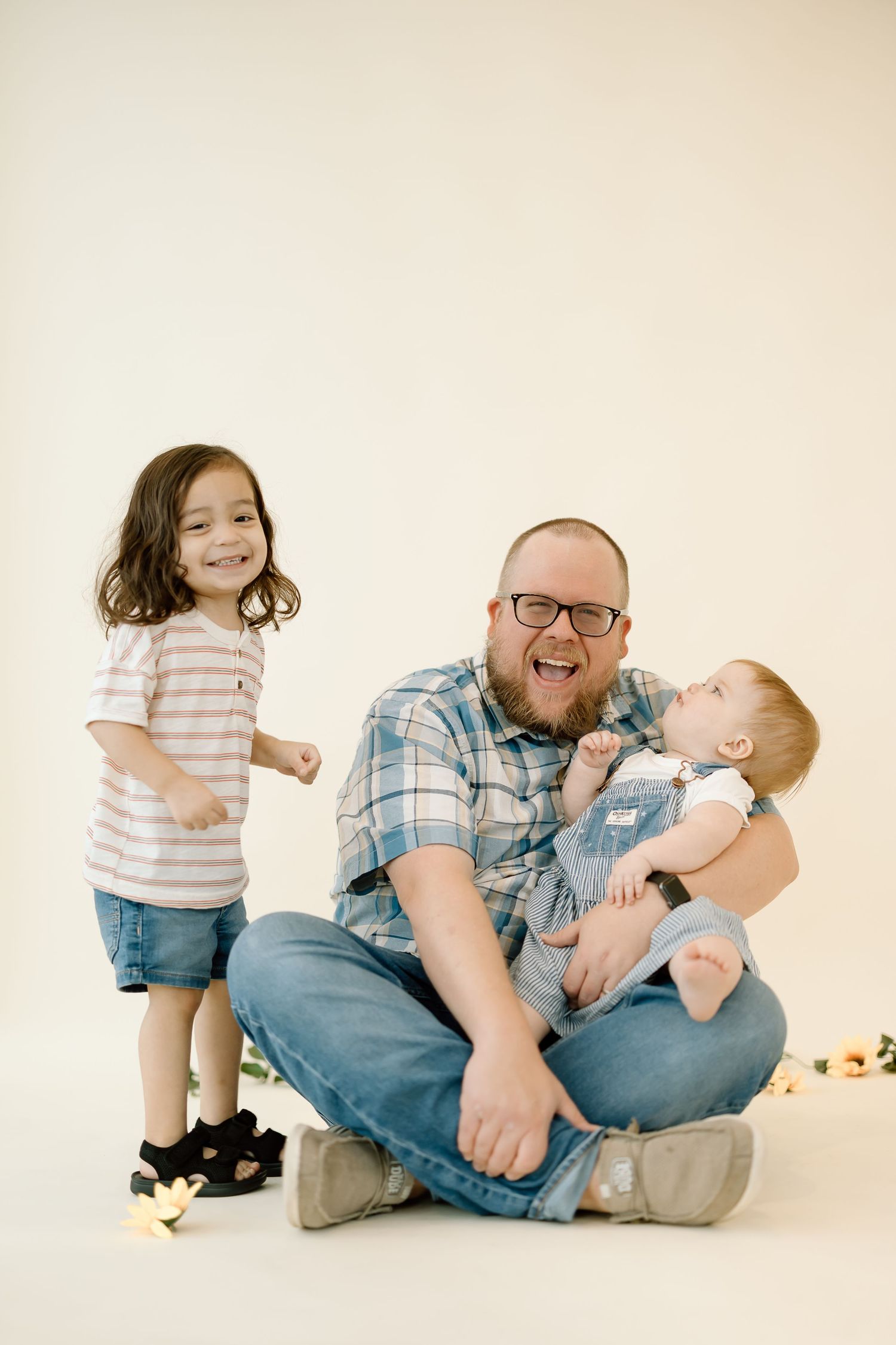 A series of candid family photos showing playful moments between parent and children on a light neutral background.