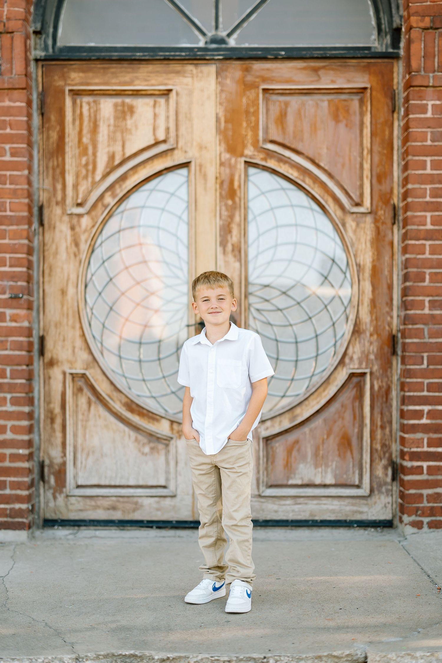 A series of vintage wooden doors with oval glass panels create an architectural backdrop.