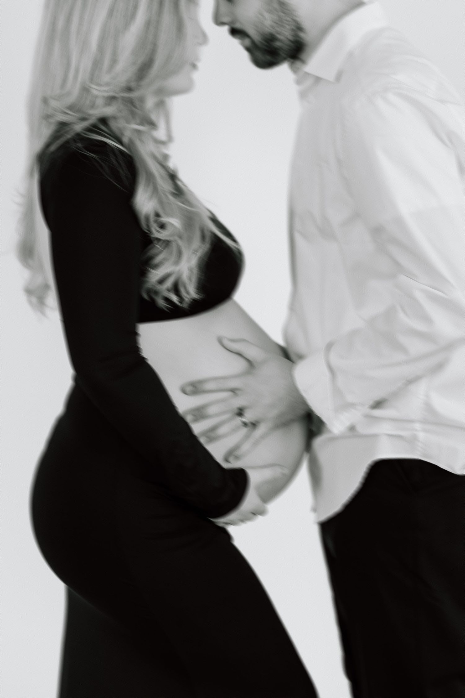 Artistic black and white portrait capturing intimate maternity moment.