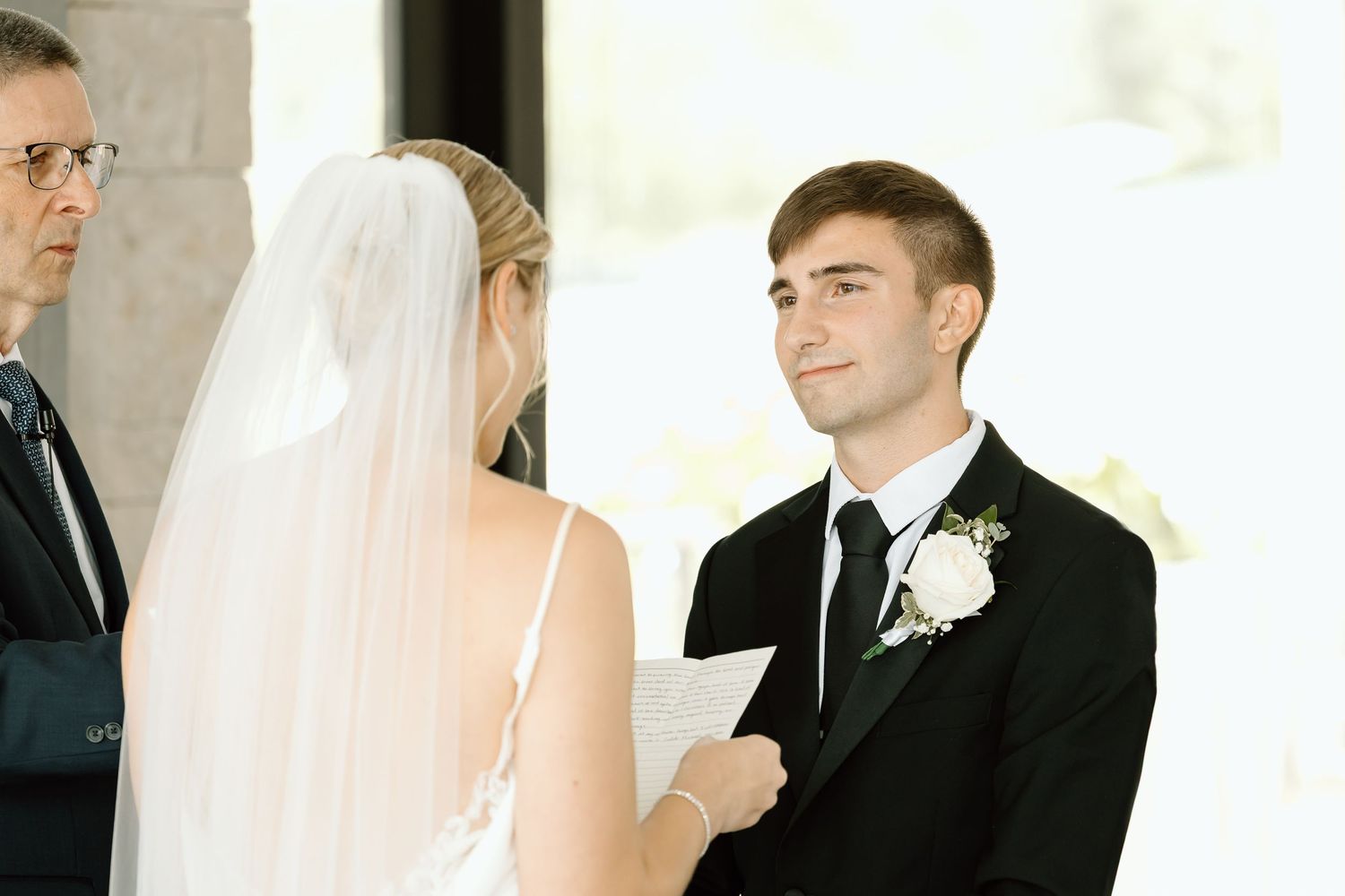A series of wedding photos showing intimate moments between a bride and groom in formal attire at their ceremony.