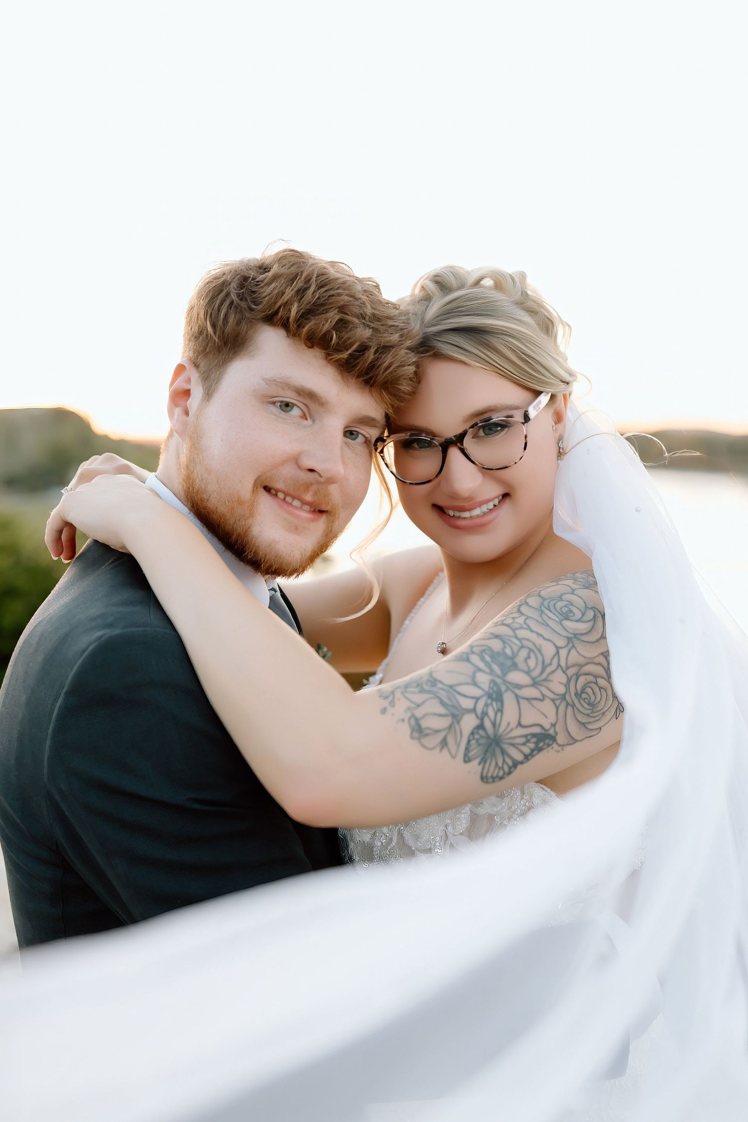 A romantic wedding photoshoot sequence showing a couple embracing in soft sunlight while wearing formal attire.