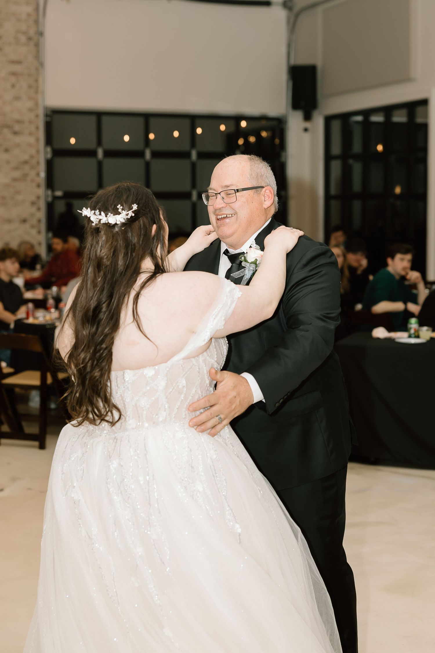 A heartwarming father-daughter dance sequence at a wedding reception shows joyful moments of celebration.