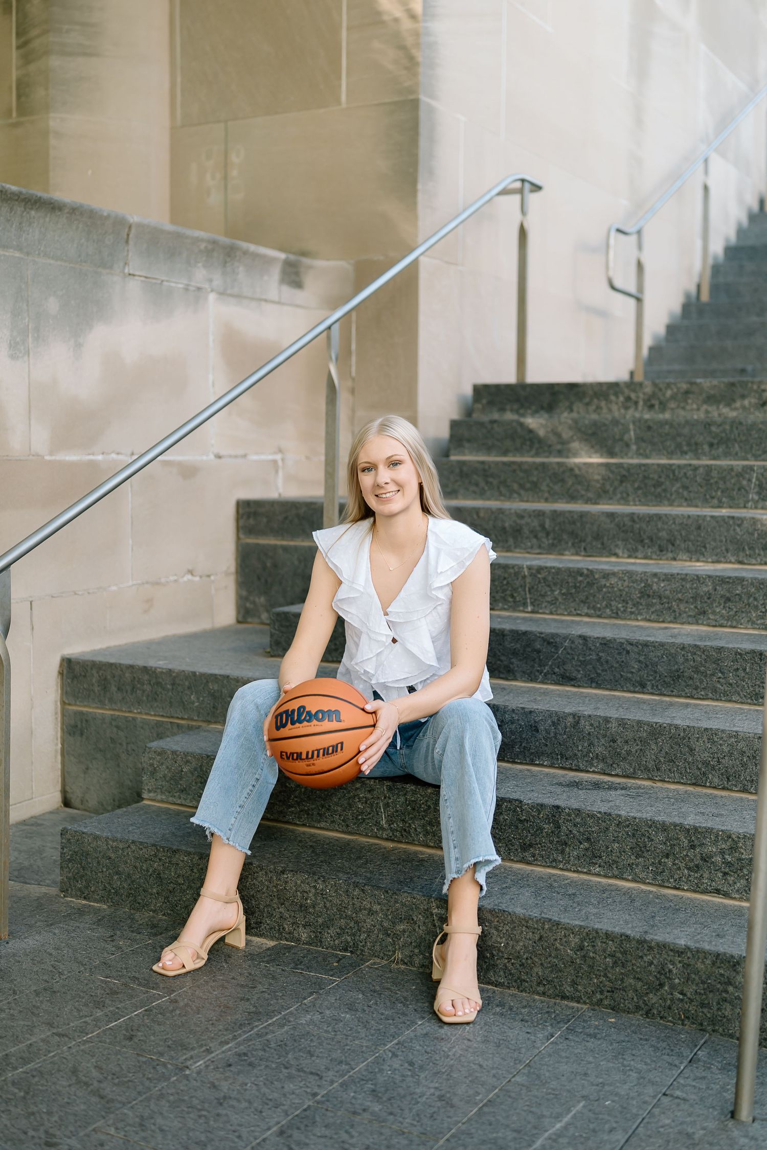A person in casual attire sits on concrete steps holding a basketball in a series of similar poses.