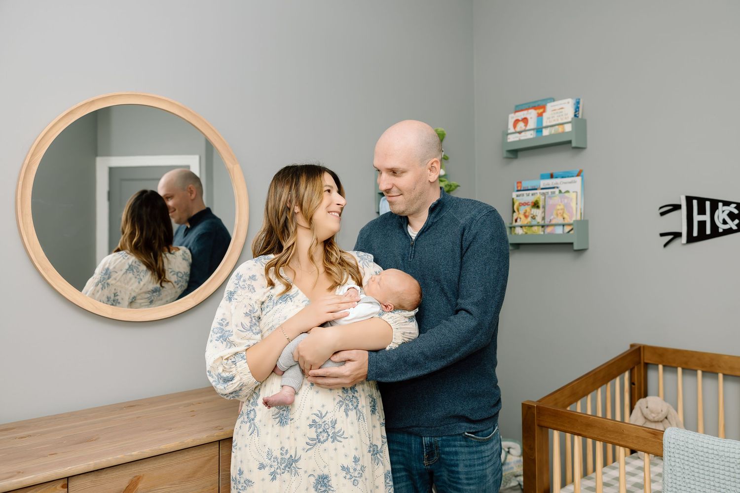 A series of five connected photos showing tender moments between parents and baby in a nursery setting.