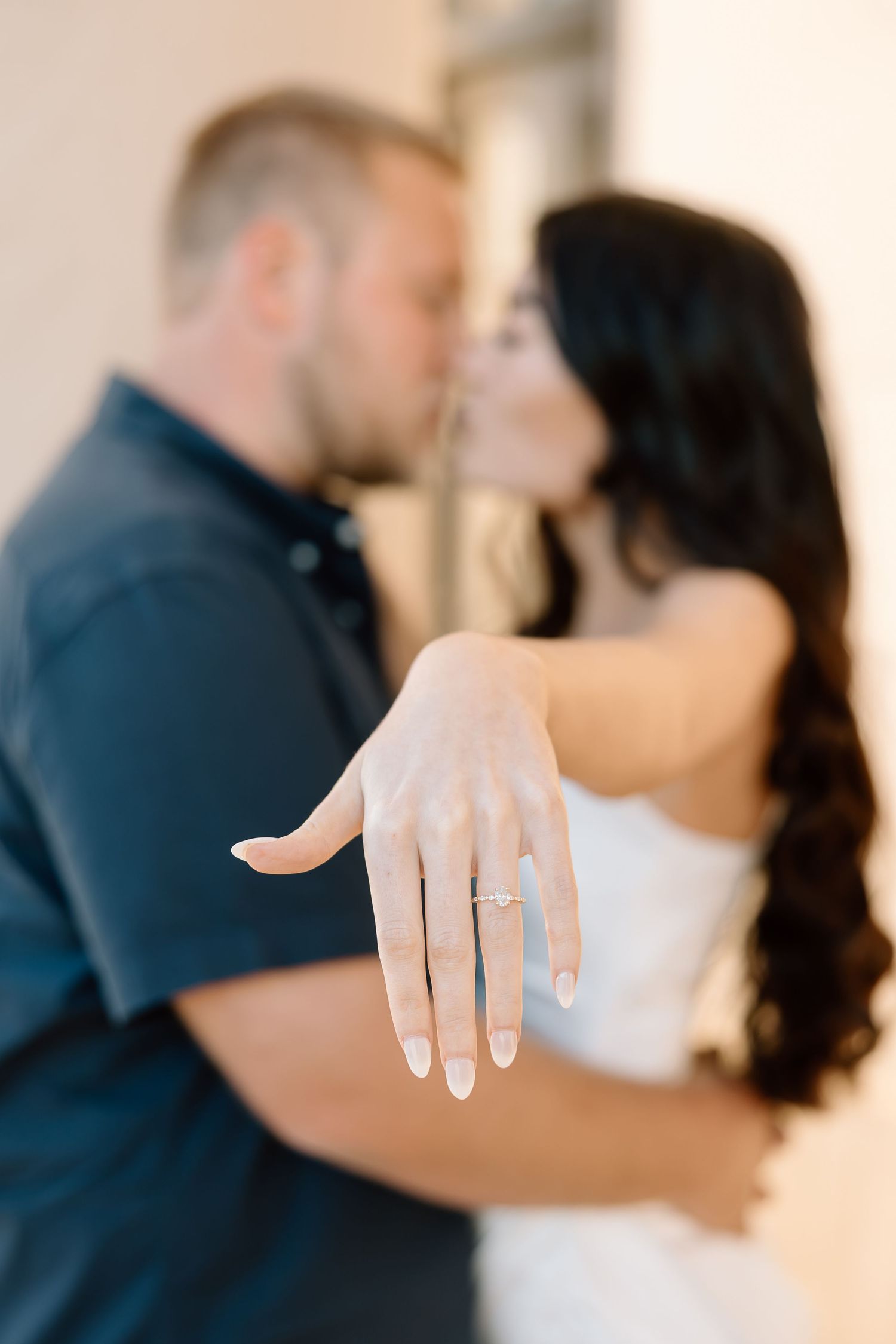 A series of close-up shots showing a diamond engagement ring on a hand against a light background.