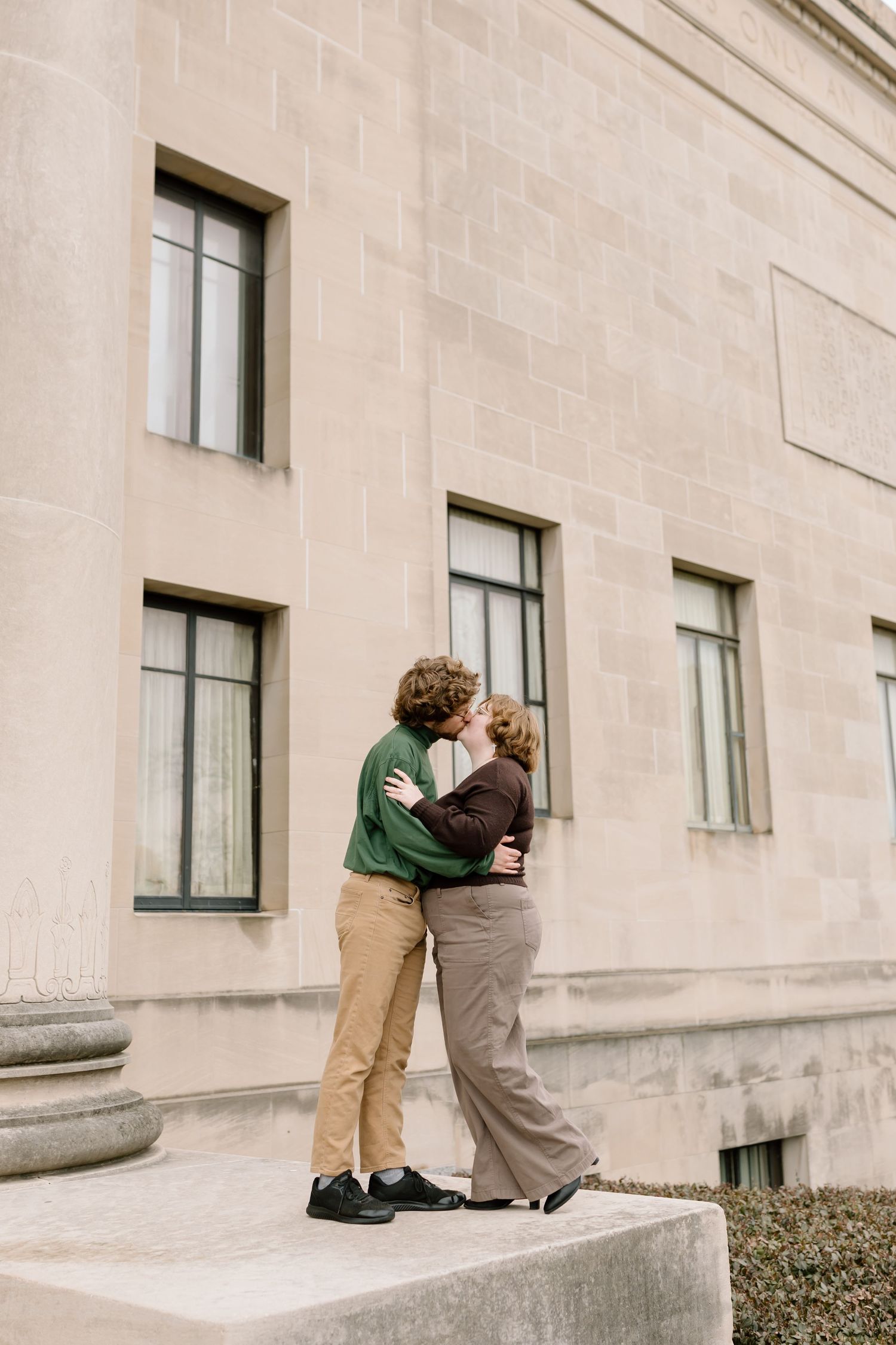 A series of four connected photos showing two people in casual clothing sitting and interacting on a stone ledge.