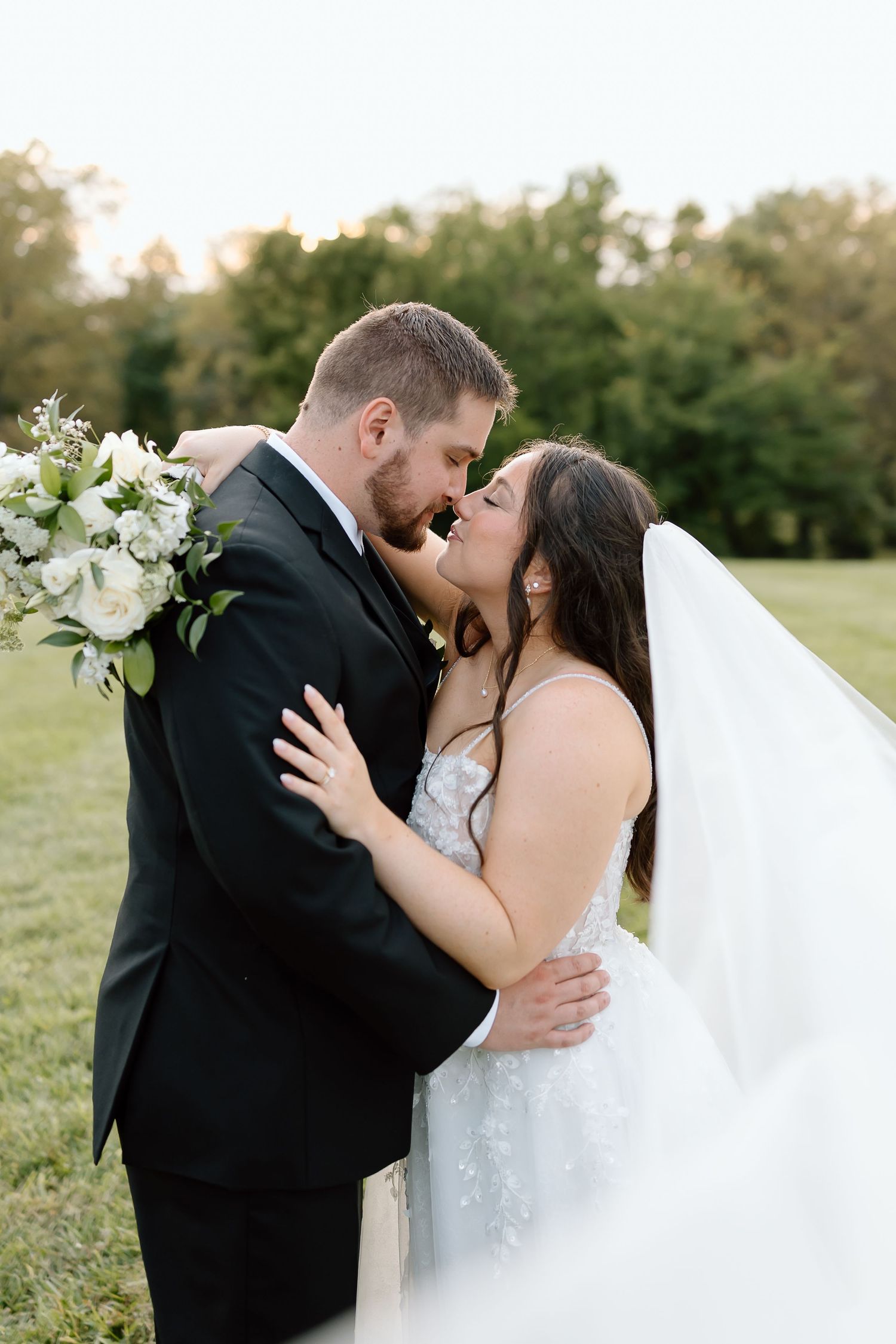 Romantic wedding couple shares intimate kisses in a series of outdoor portraits with natural lighting at sunset.