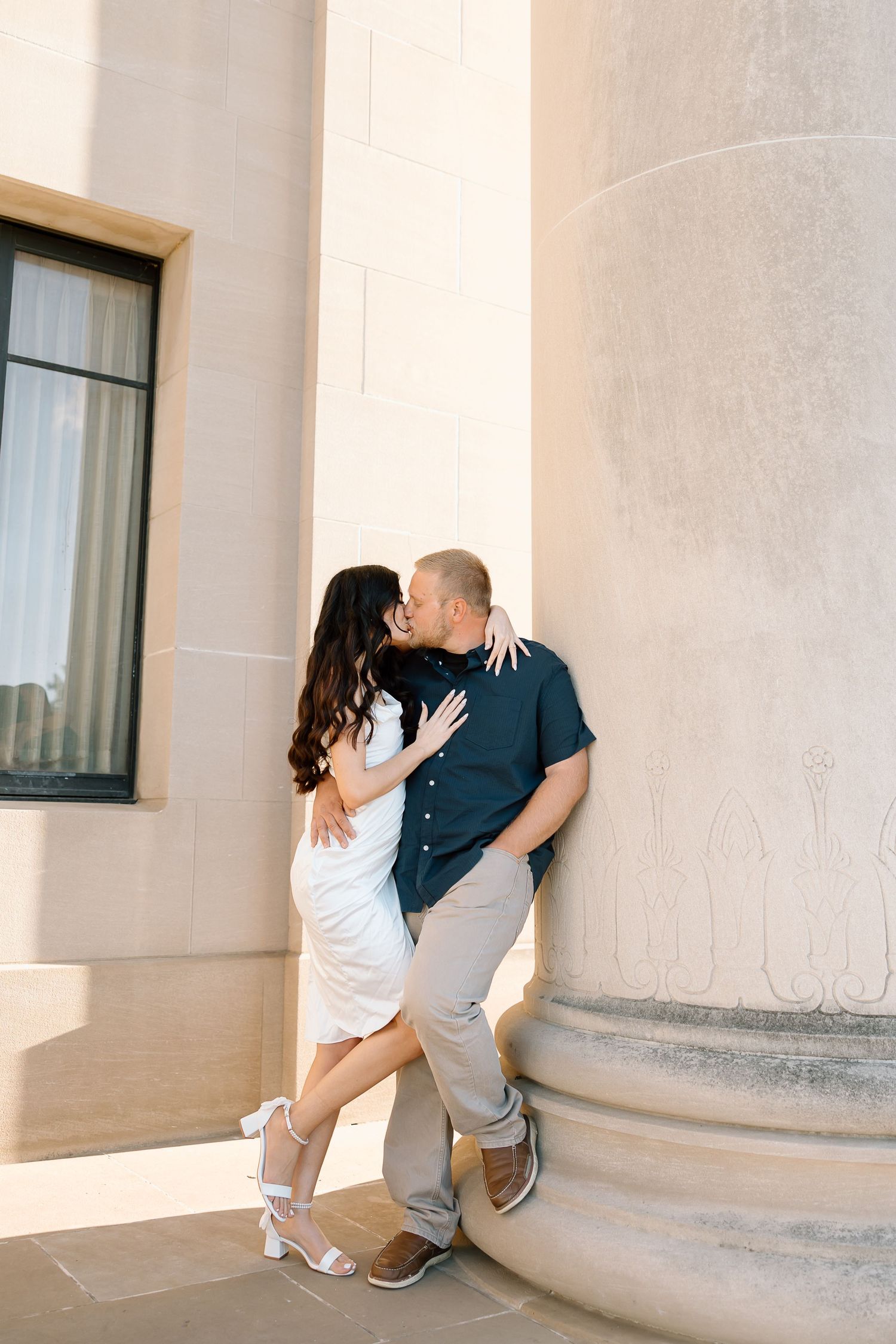 A couple shares a romantic moment in a sequence of four photos against a light-colored building exterior.