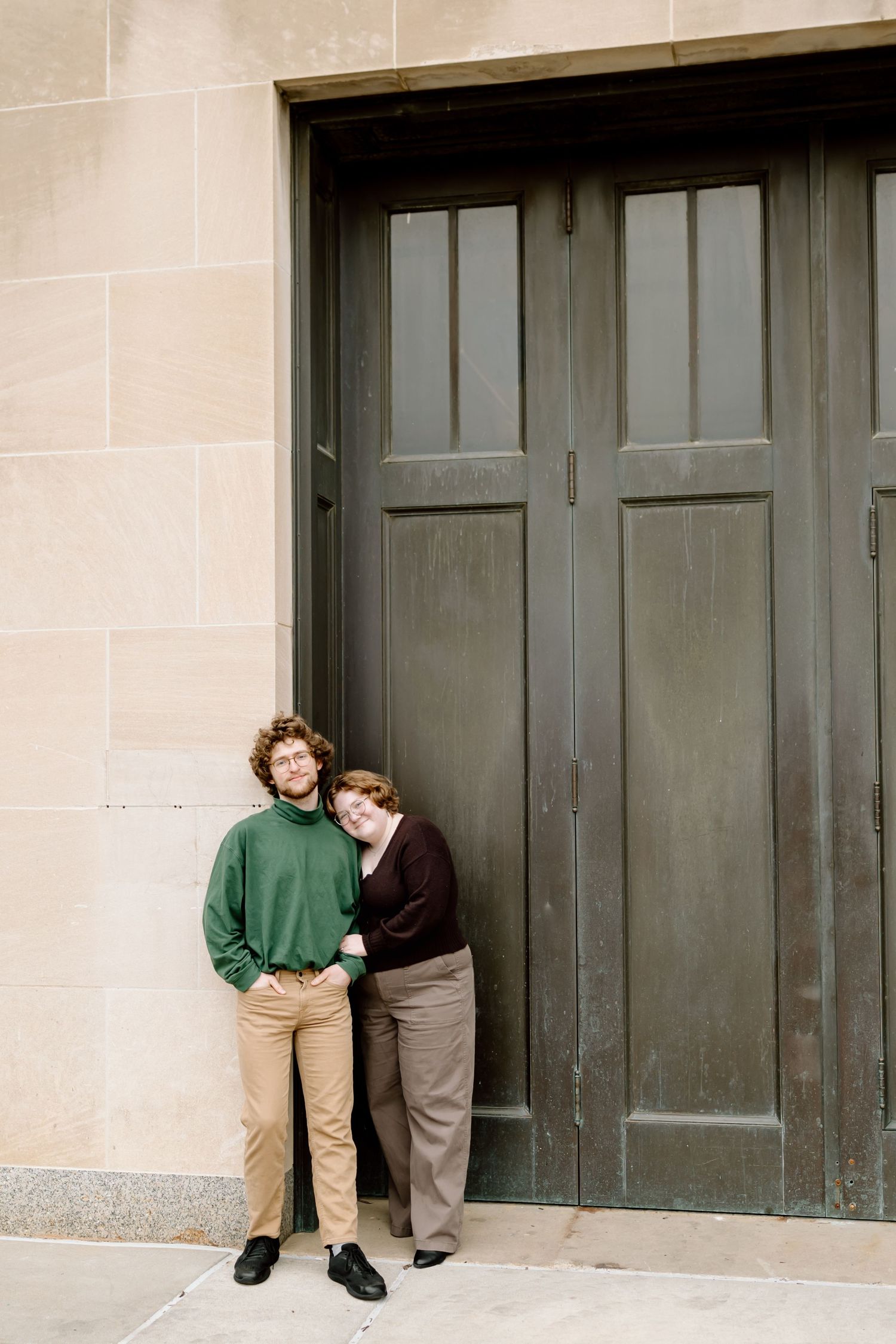 Three sequential photos show a playful couple posing against wooden doors on a beige stone wall.