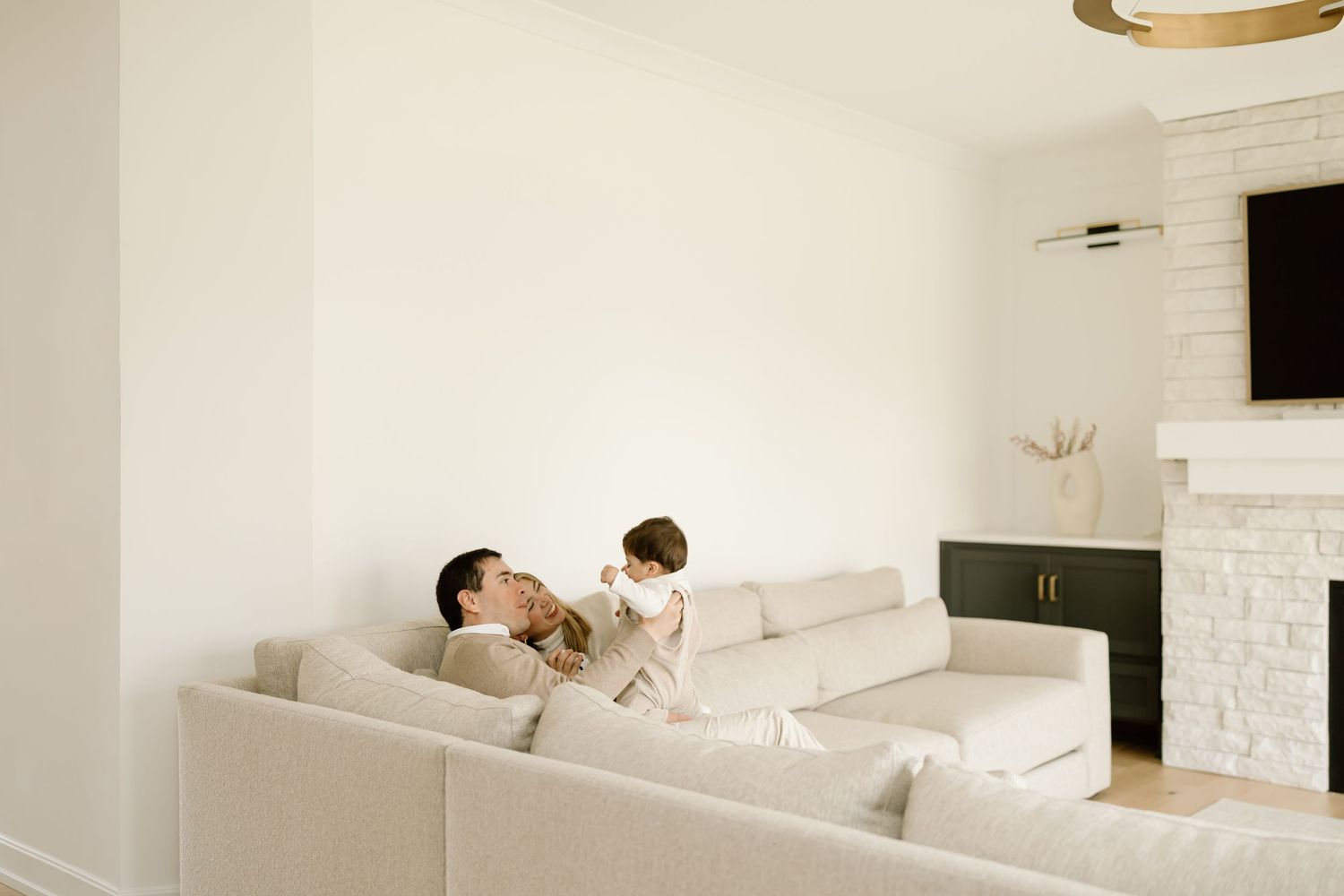 A sleek modern white bedroom features a minimalist design with floating shelves and soft ambient lighting.