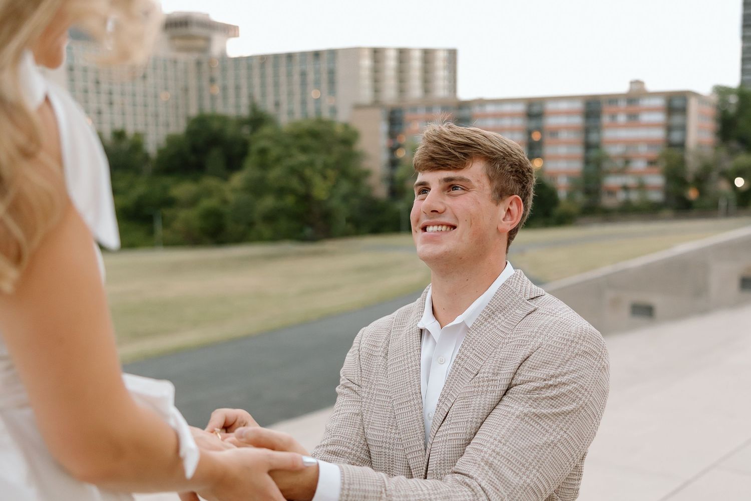 A series of photos showing a person in a light gray suit sitting at an outdoor table during a sunny day.