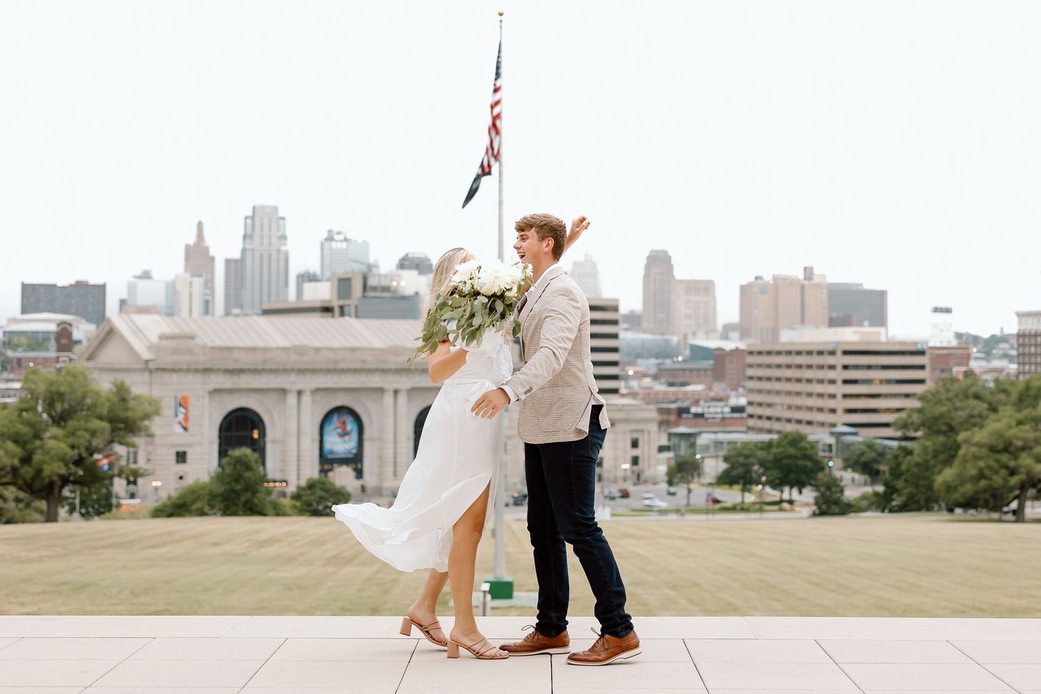A couple dances playfully in a sequence of four photos with the city skyline in the background.