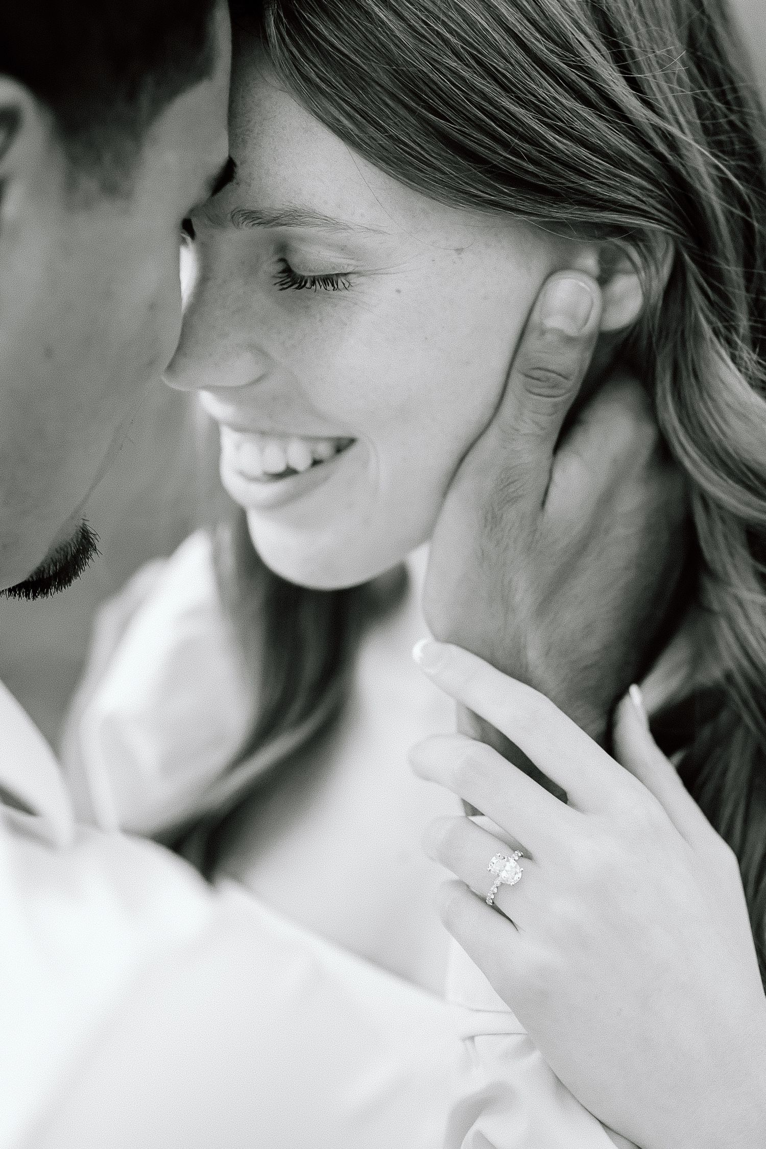 A romantic black and white photo series showing tender intimate moments between a couple in soft lighting.