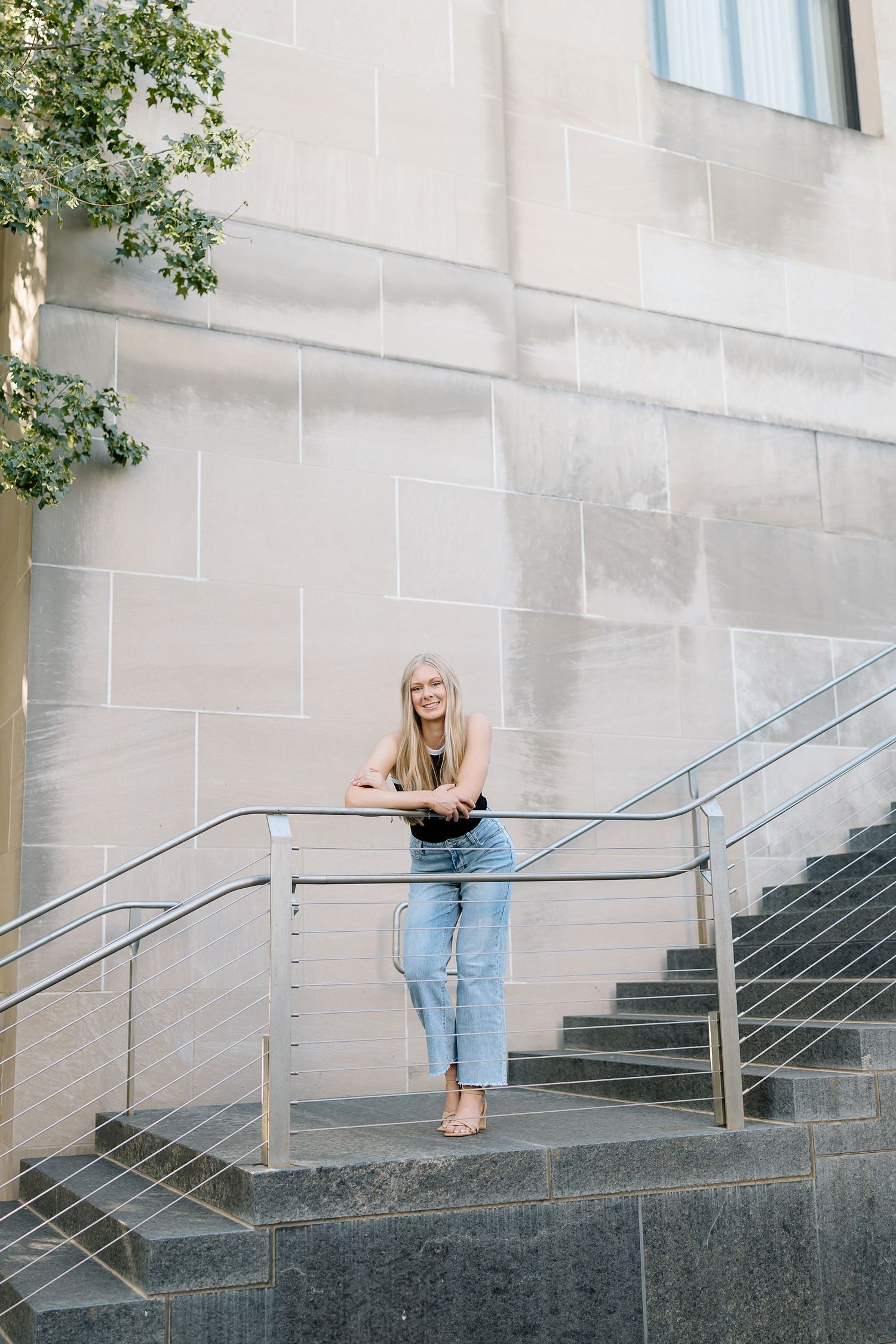 A sequence of photos showing someone in jeans leaning on a metal railing outside a building with stone steps.