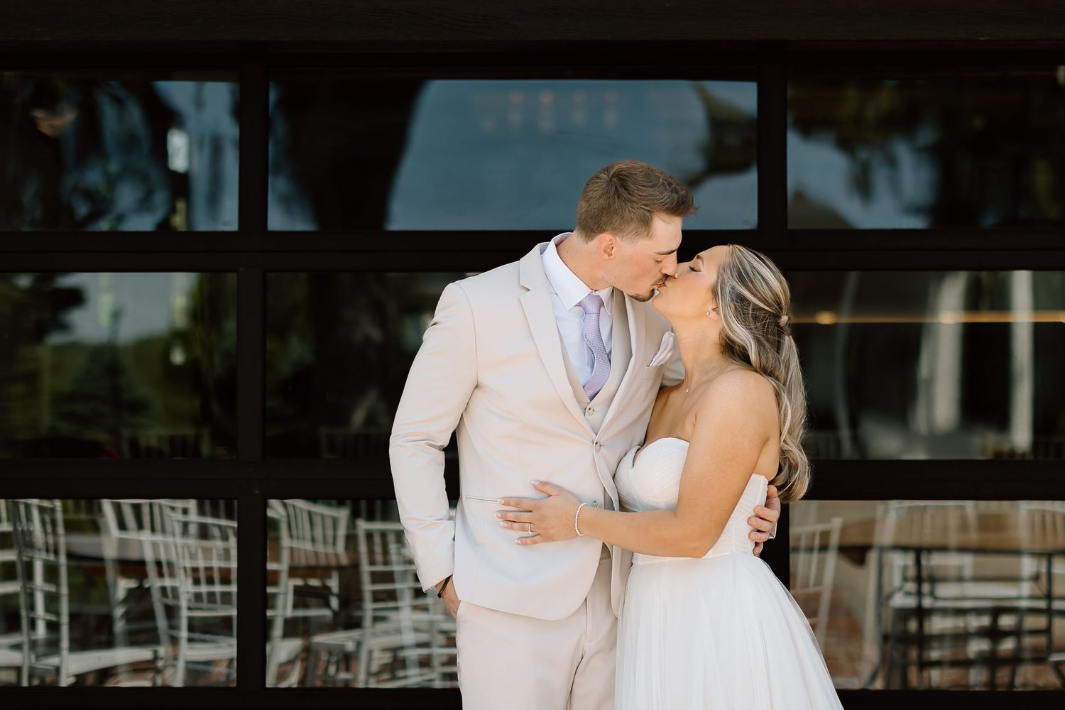 Romantic first look moment between couple outside wedding venue.
