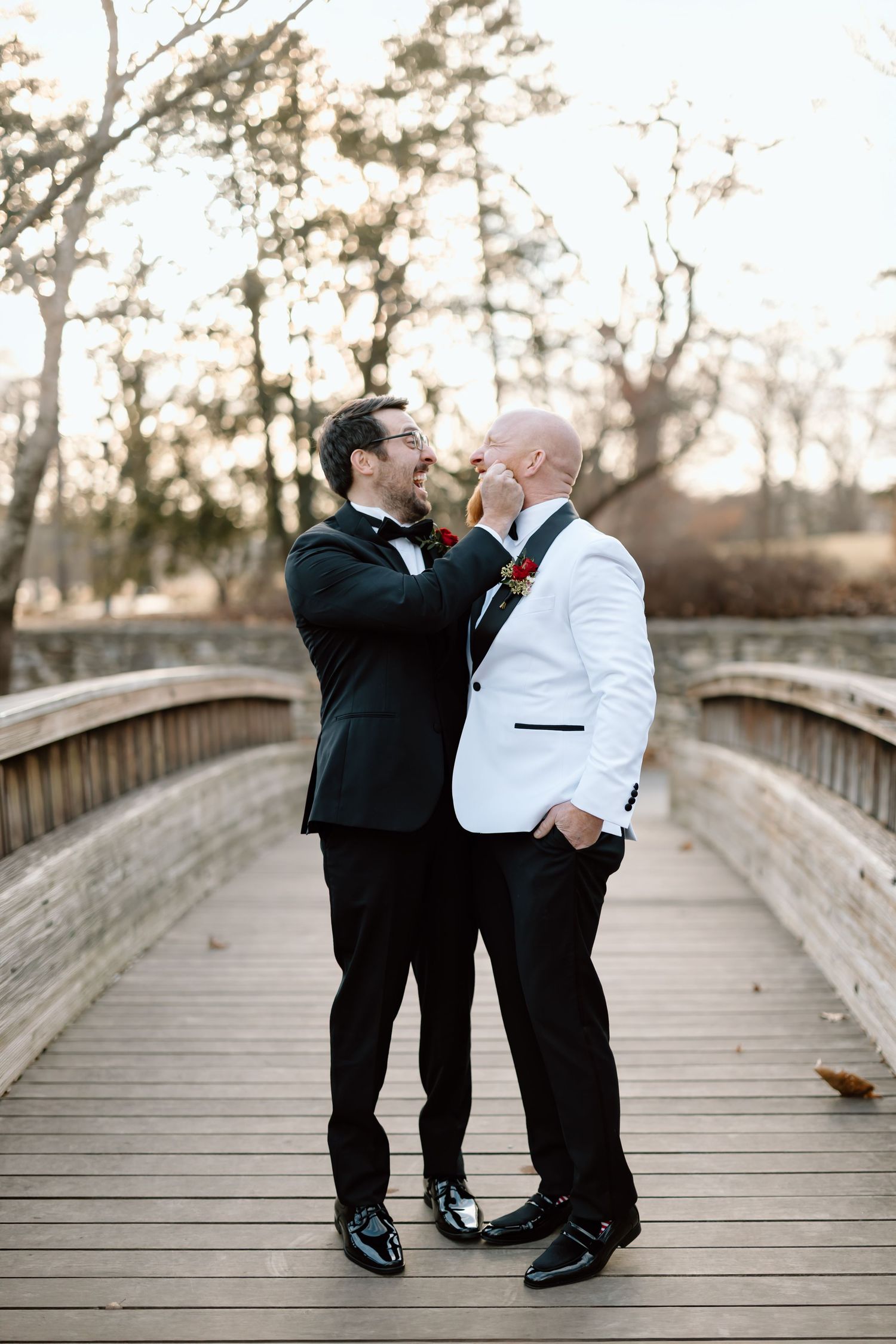 A romantic couple dancing and dipping on a wooden bridge during sunset.