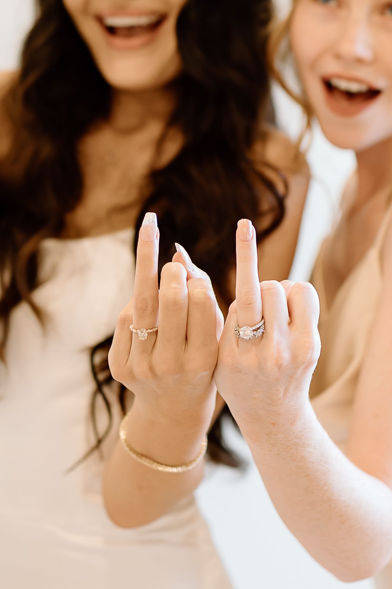 A series of photos showing hands displaying engagement rings and wedding bands against a white background.