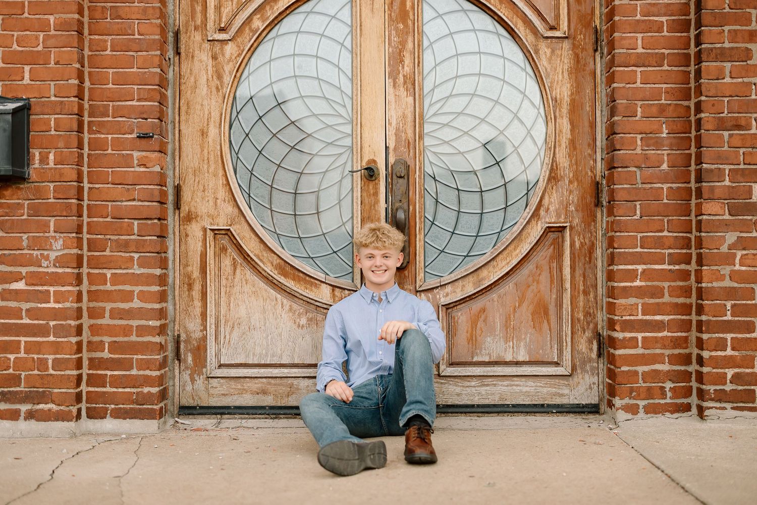 A series of four photos showing someone sitting in different positions against a rustic wooden door with circular windows.