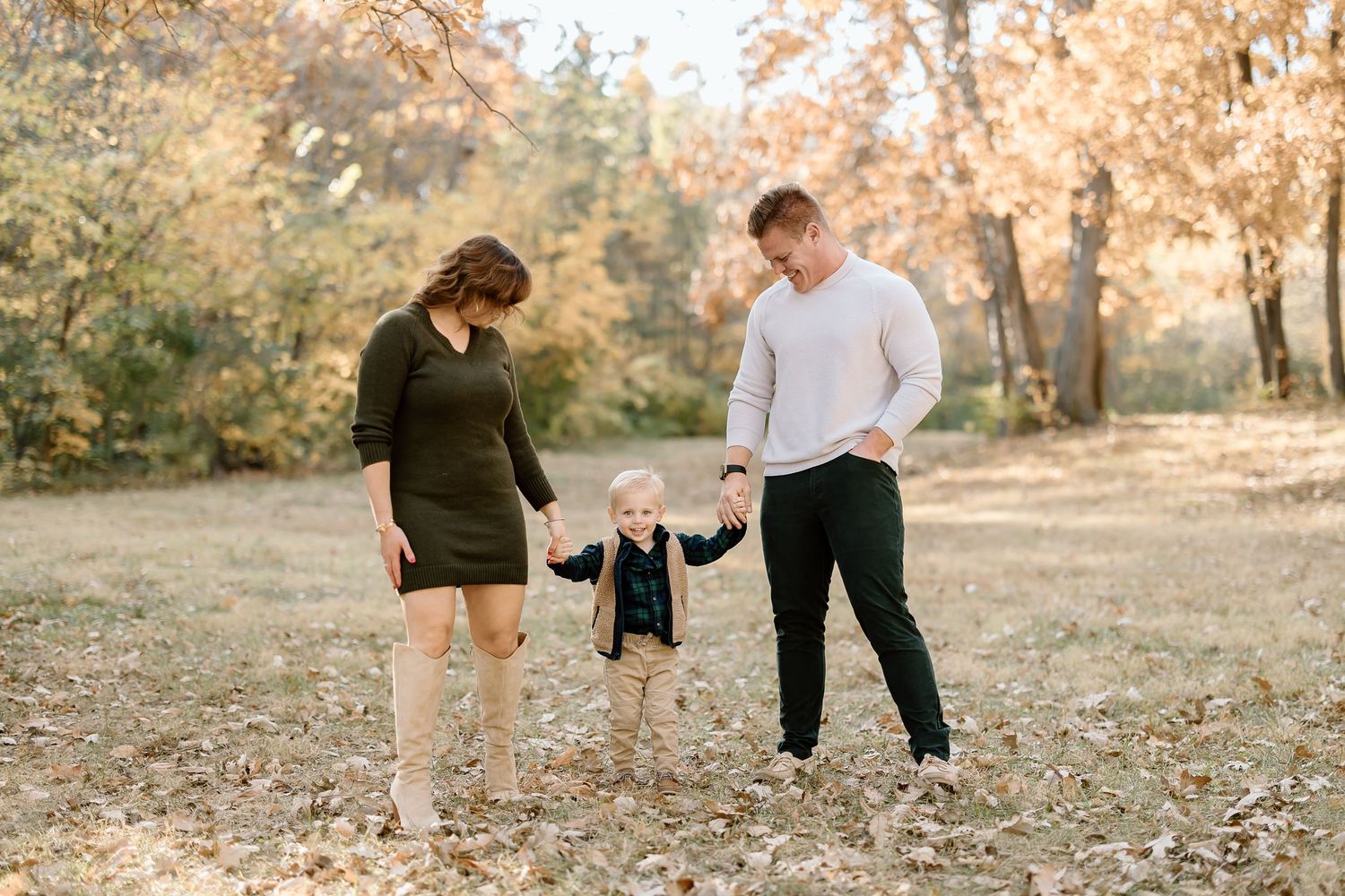Family sharing tender moment together in autumn setting with golden light.
