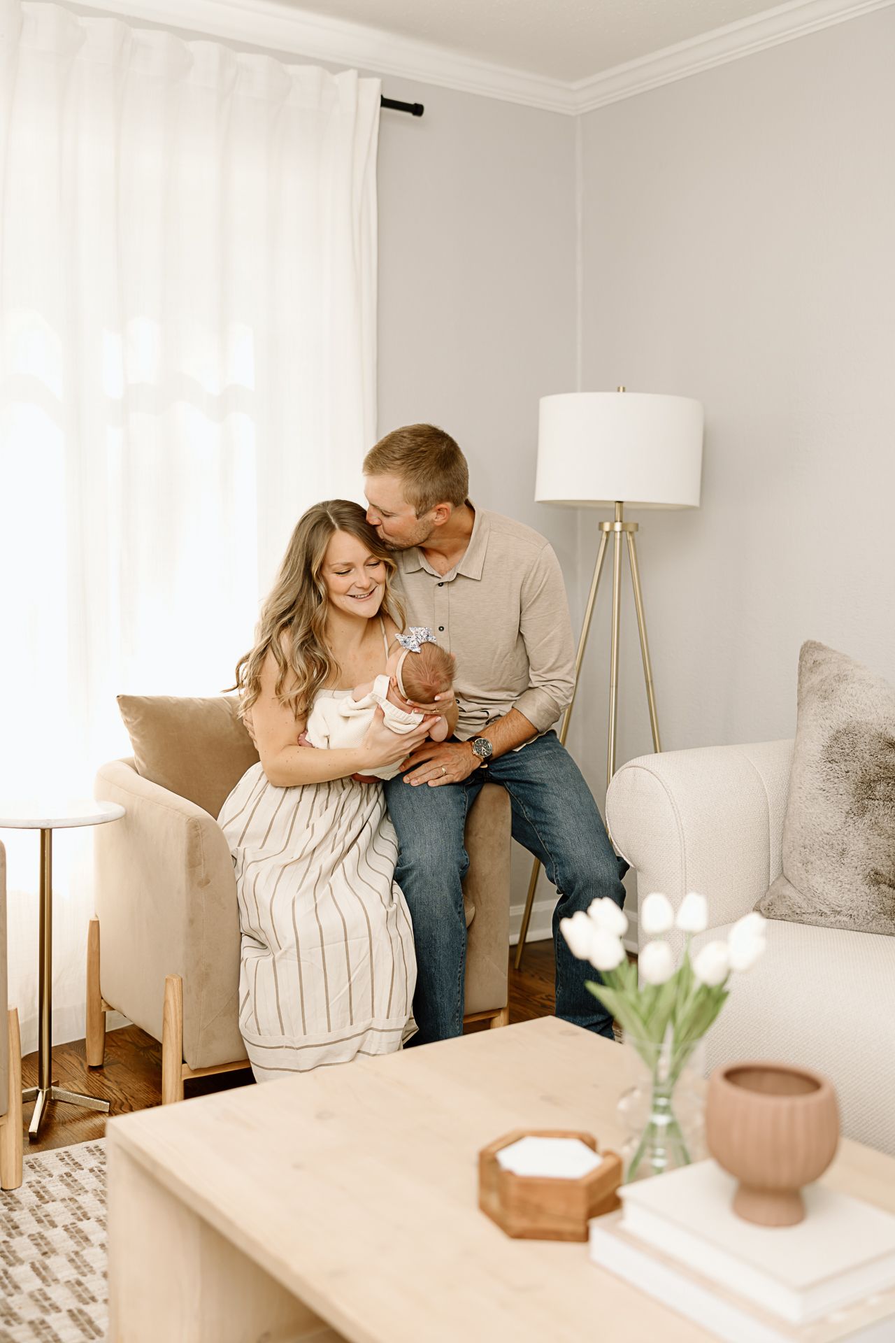 Sweet family moment captured in contemporary living room with neutral decor.