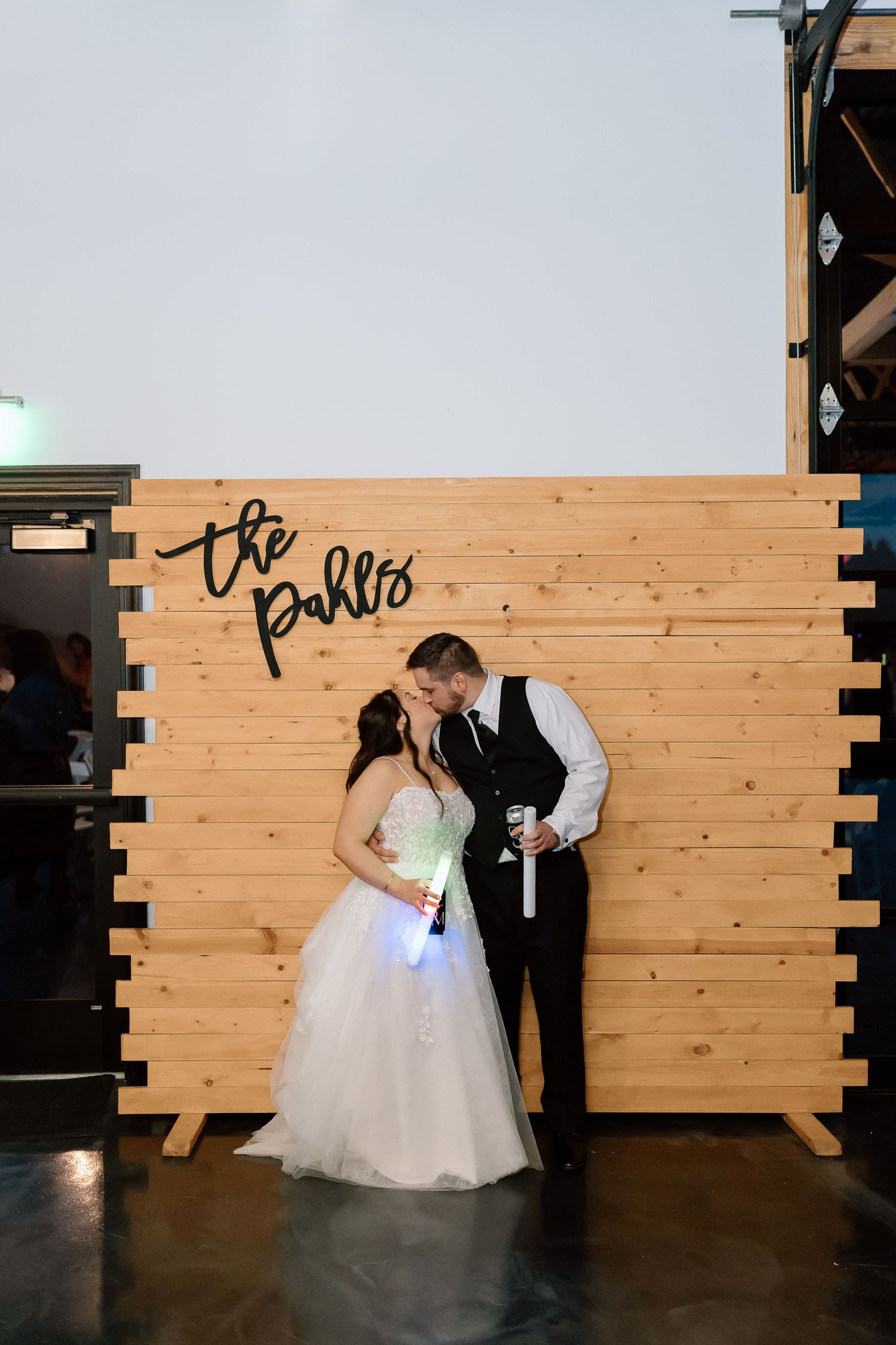 A romantic sequence of dance dips against a wooden panel backdrop during a wedding celebration.