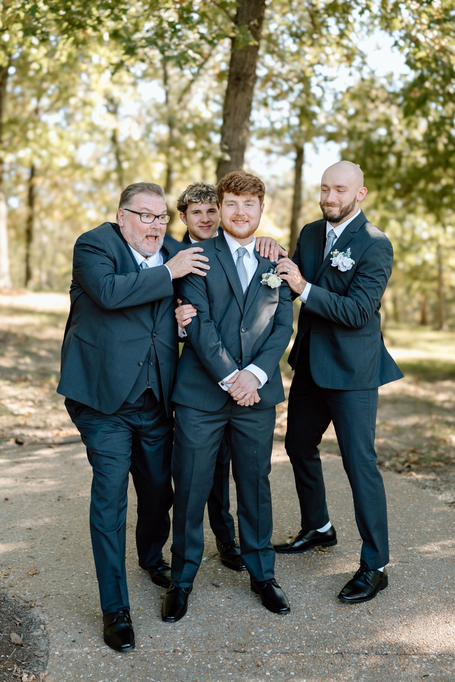 A sequence of candid wedding party photos showing groomsmen in navy suits laughing and posing together outdoors.