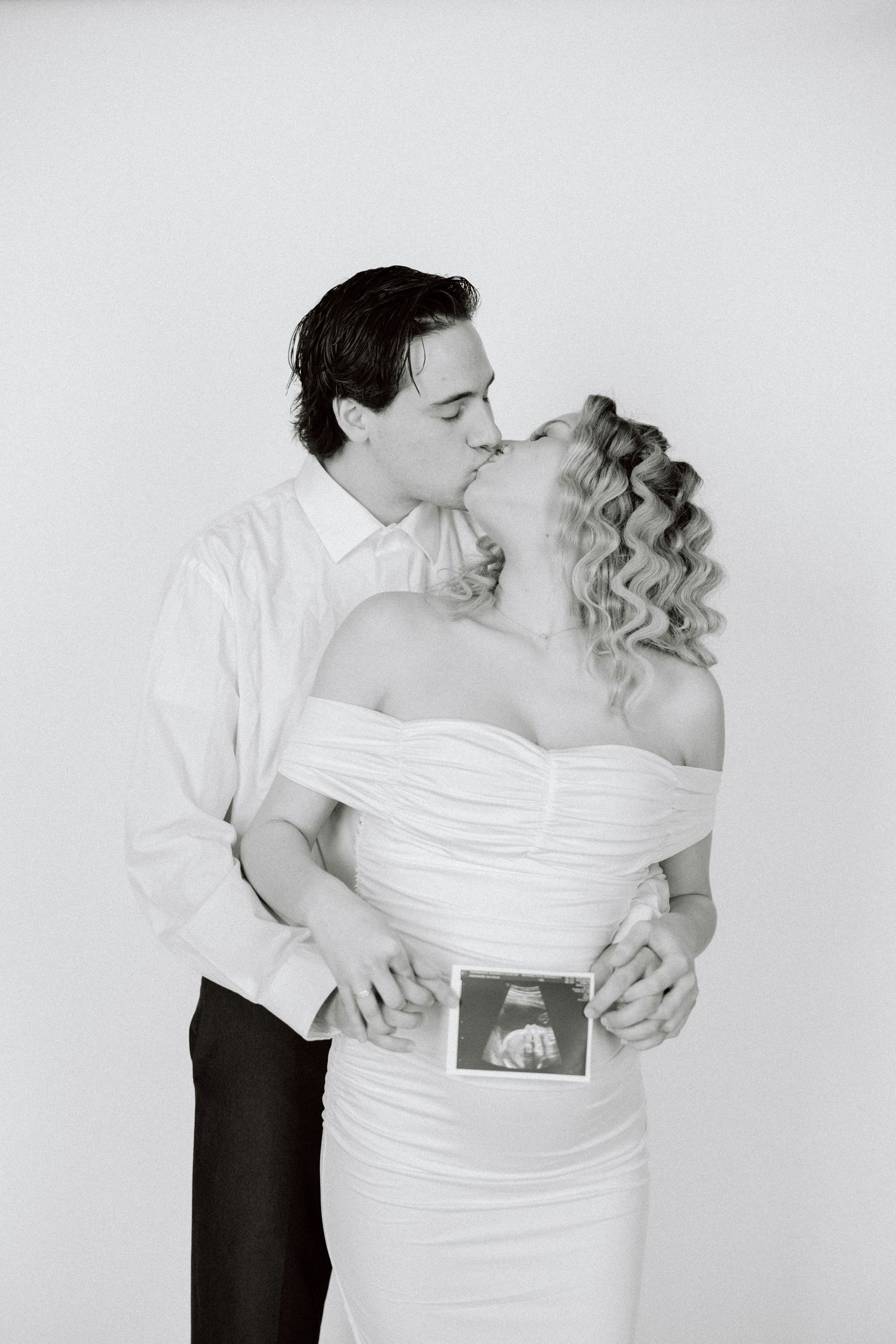 A romantic black and white photo sequence shows a couple embracing and dancing together.