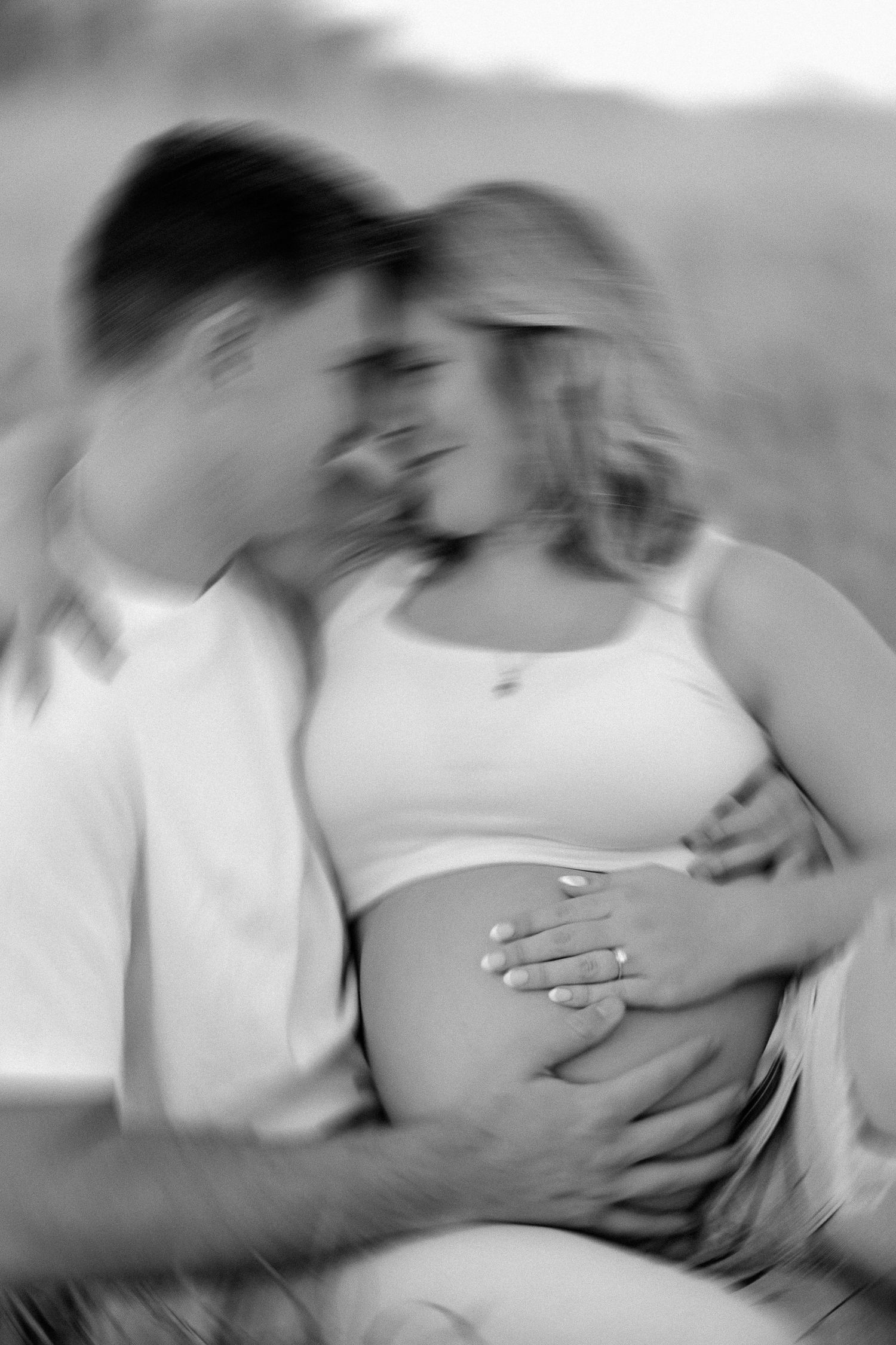 A romantic black and white photo series showing a couple kissing in an intimate sequence of five connected images.