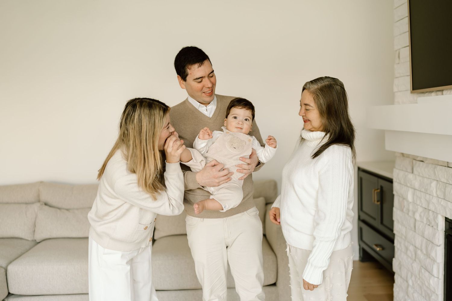 A series of connected images showing a family in white clothing posing together on a couch in a bright studio setting.
