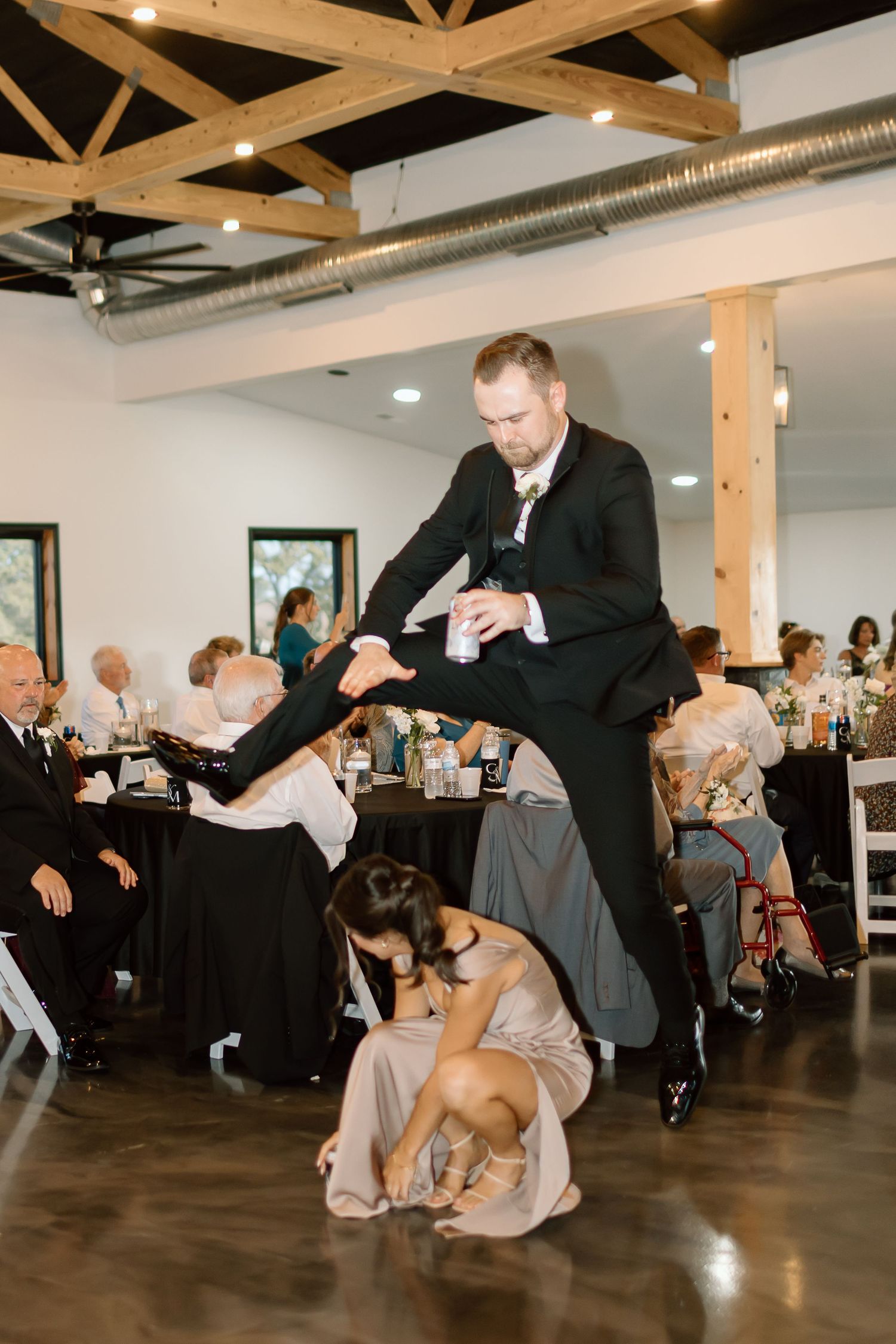 A sequence of dance moves with a large dog joining in on the dance floor at a wedding reception.