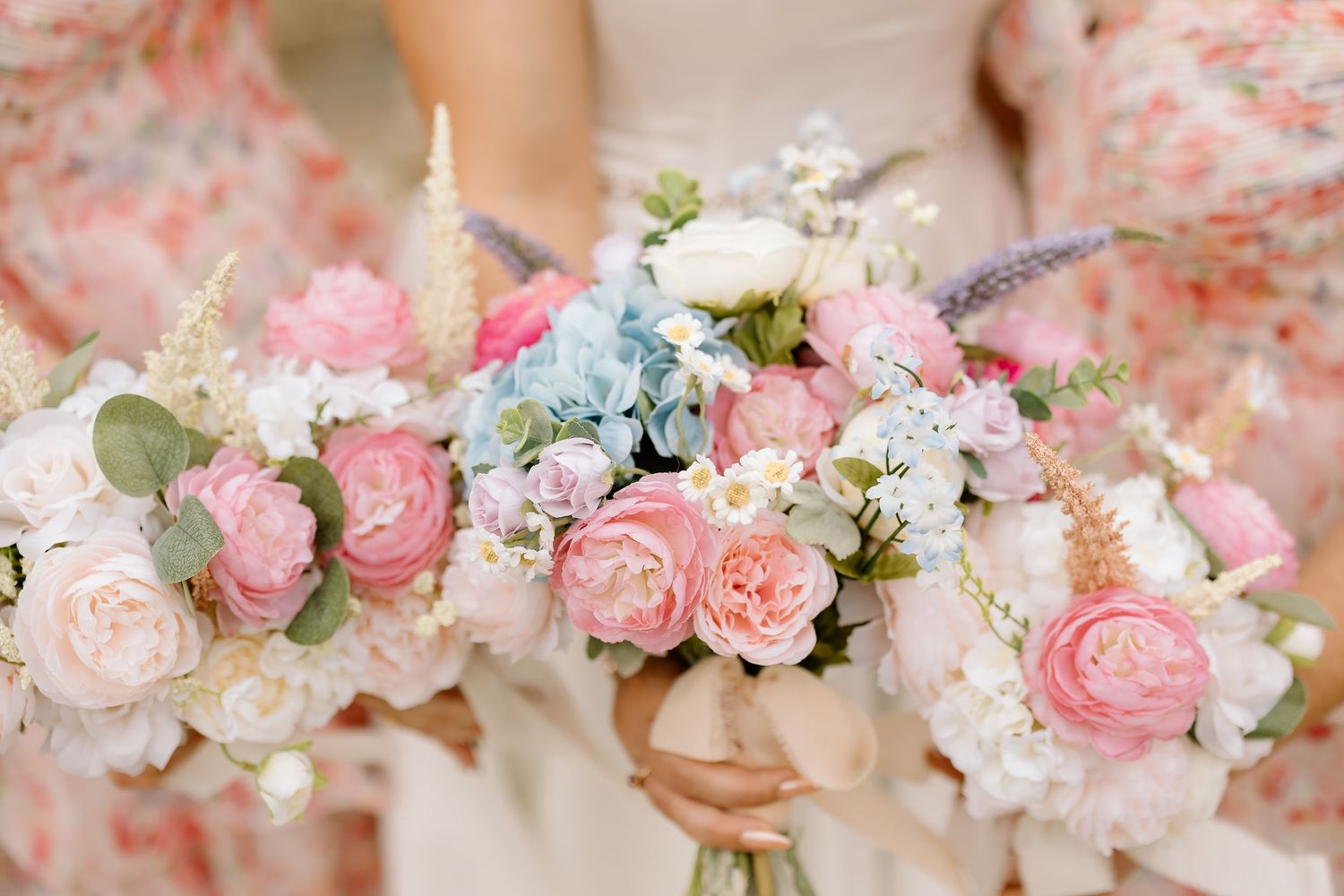 A collection of delicate pink and white floral bouquets with roses and baby's breath arranged in a romantic style.