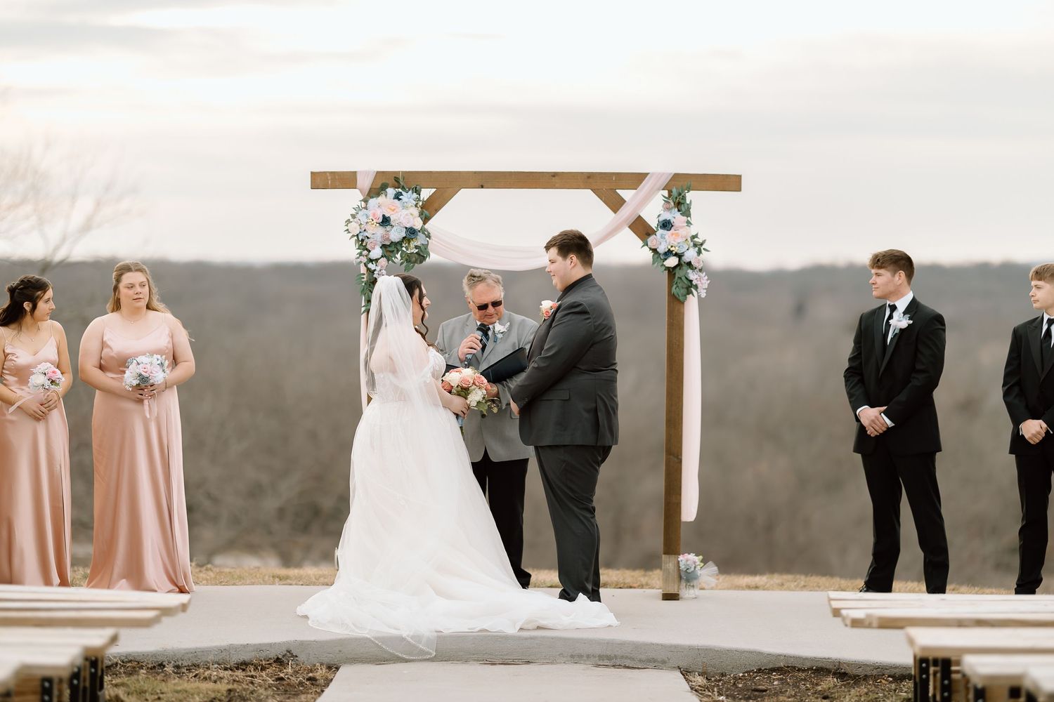 A collection of romantic wedding ceremony and portrait moments captured at an outdoor venue with scenic mountain views.