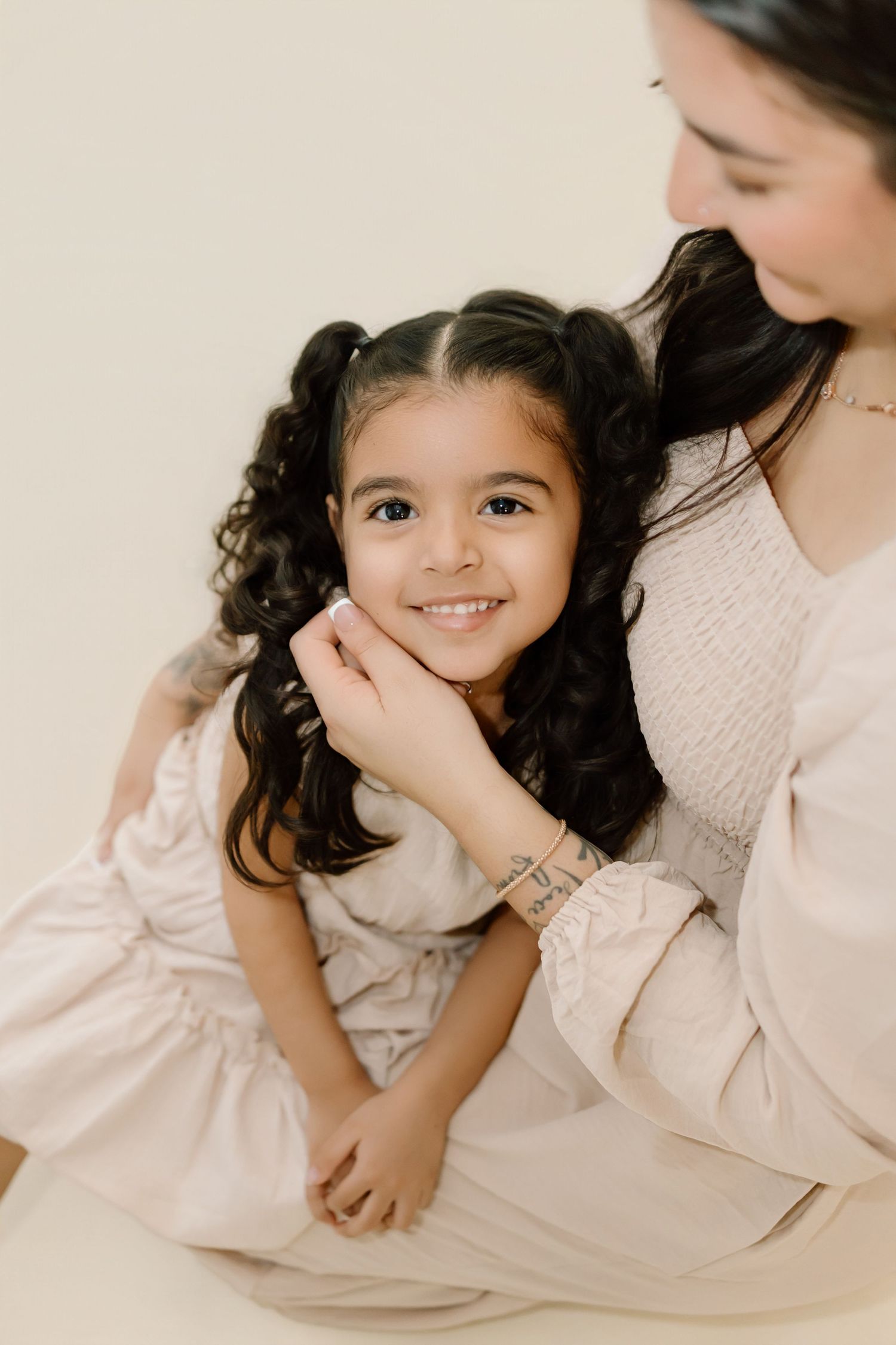 A series of tender lifestyle portraits showing gentle moments between parent and child in soft, neutral tones.