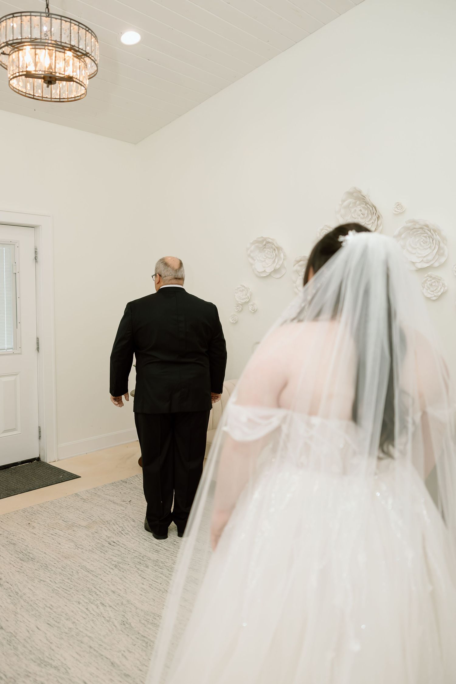 A series of wedding photos showing a bride in a white gown and veil walking with someone in black formal attire.