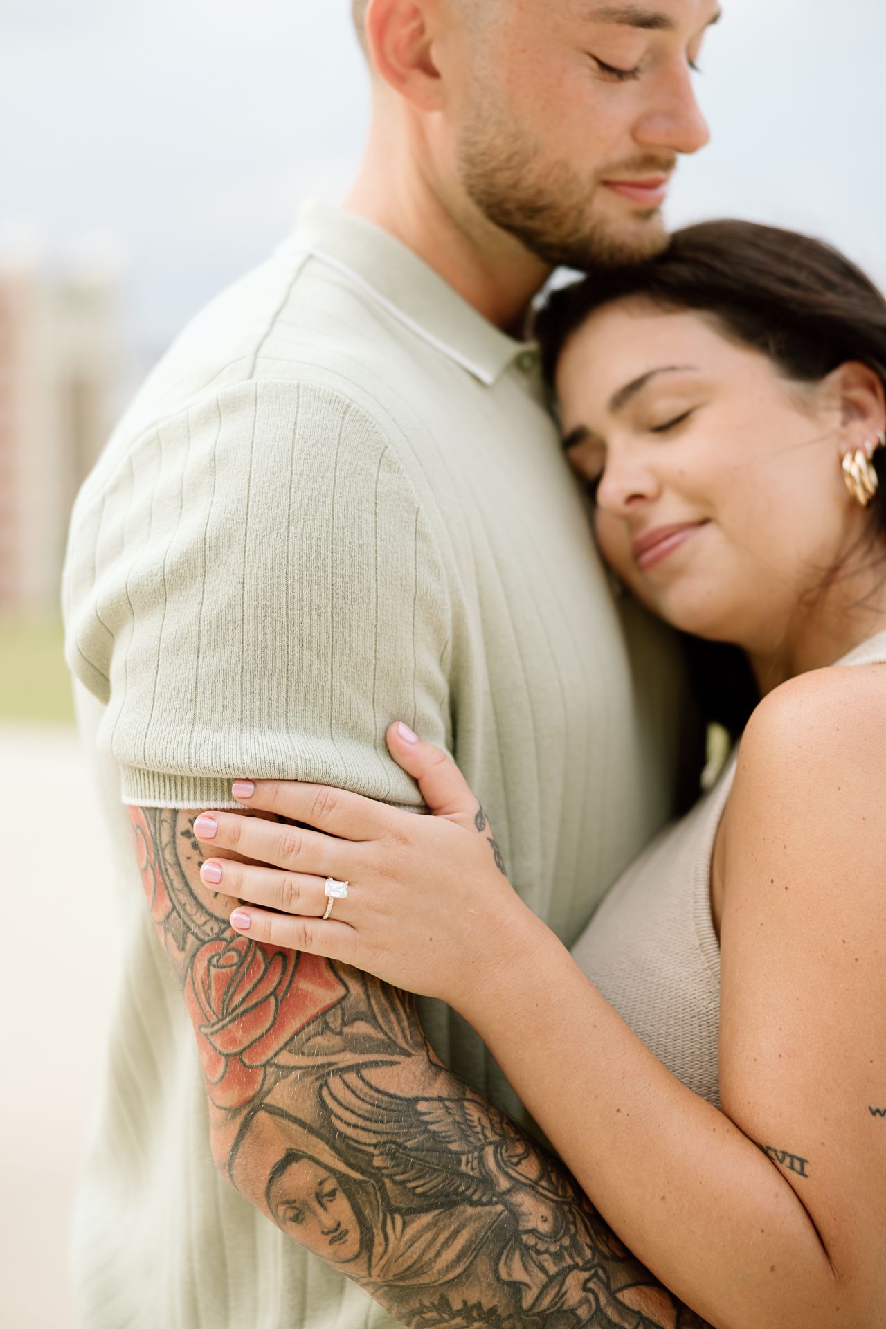 Close-up shots of a couple embracing, showing a detailed arm tattoo and intimate moments.