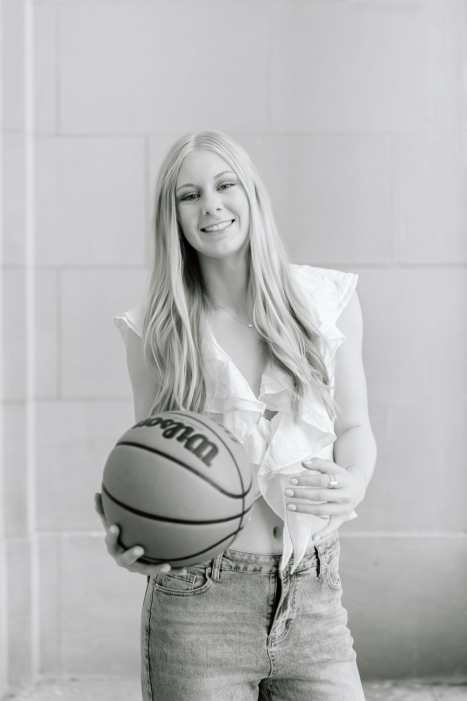 Black and white photo series showing a casual portrait session with a basketball and denim jeans against a light background.
