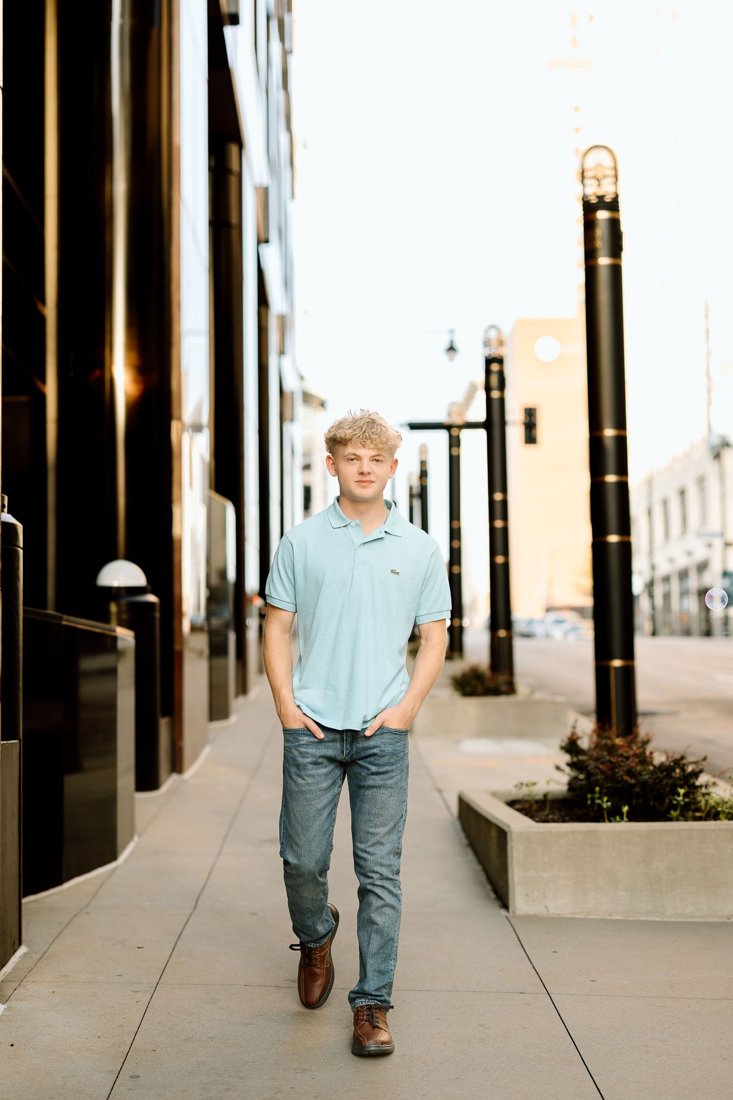 A sequence of five photos showing someone walking along an urban sidewalk with black columns in varying perspectives.
