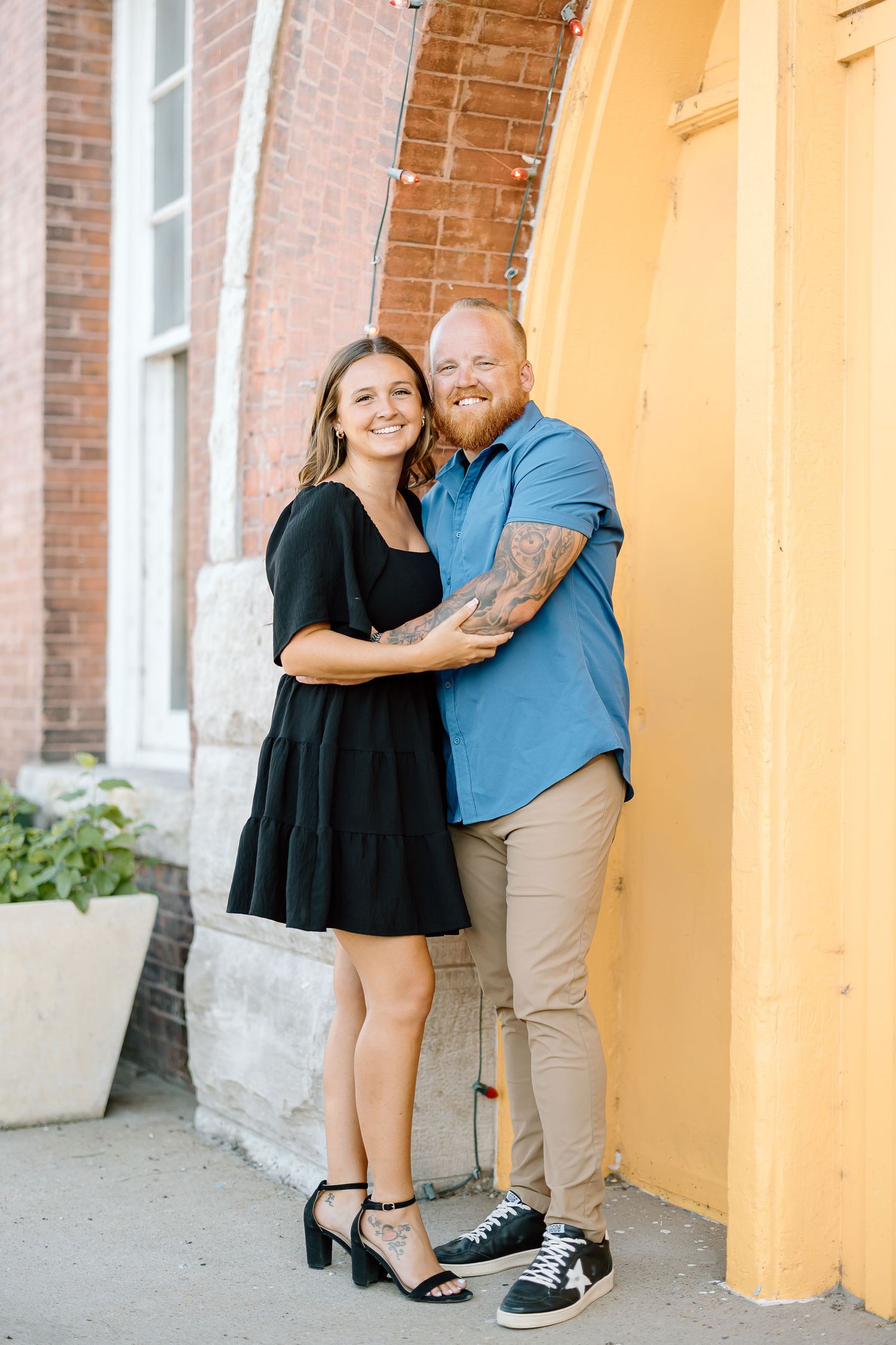 Three casual family photos taken against an orange column and brick wall backdrop.
