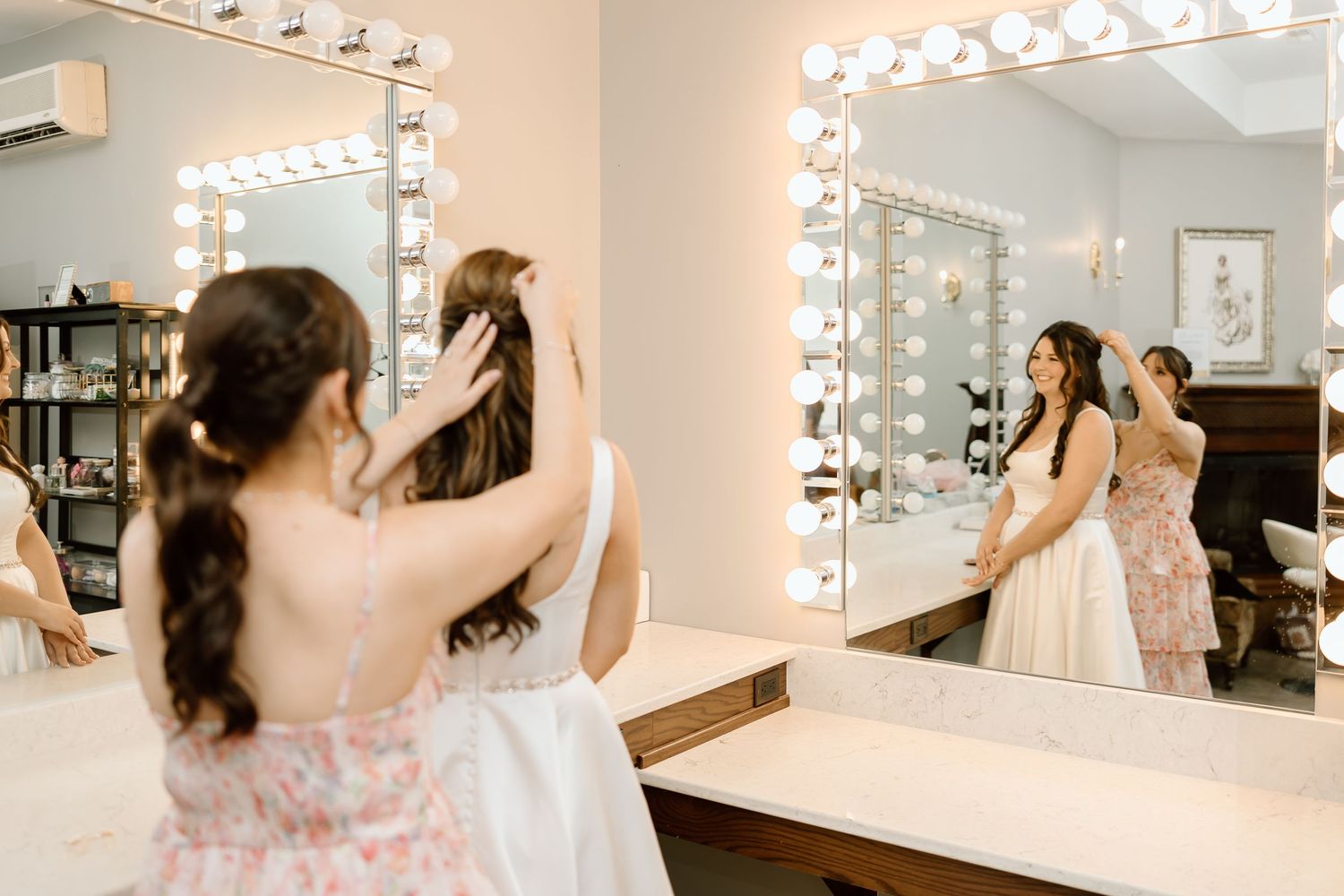 A sequence of photos showing someone styling their hair in a brightly lit dressing room with illuminated vanity mirrors.