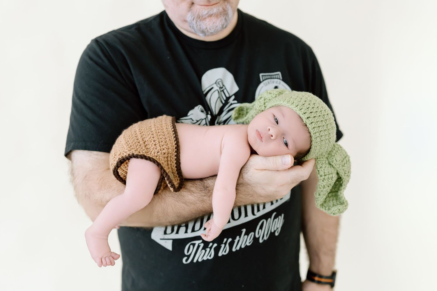 A series of four progressive photos showing a baby being gently cradled and comforted in someone's arms.