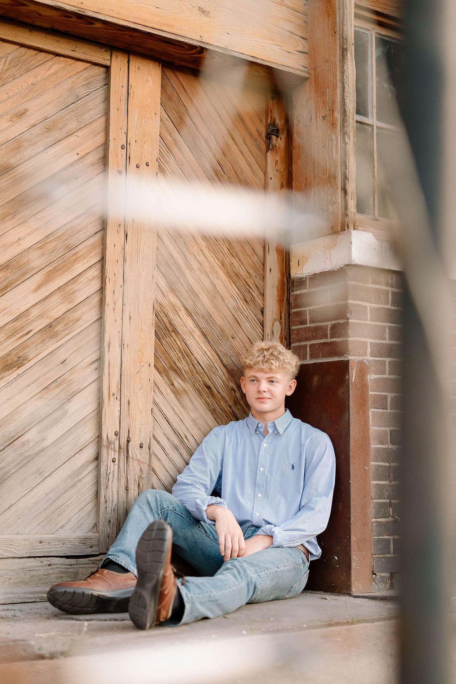 Three artistic photos of someone sitting against a rustic wooden wall with diagonal planks and brick accents.
